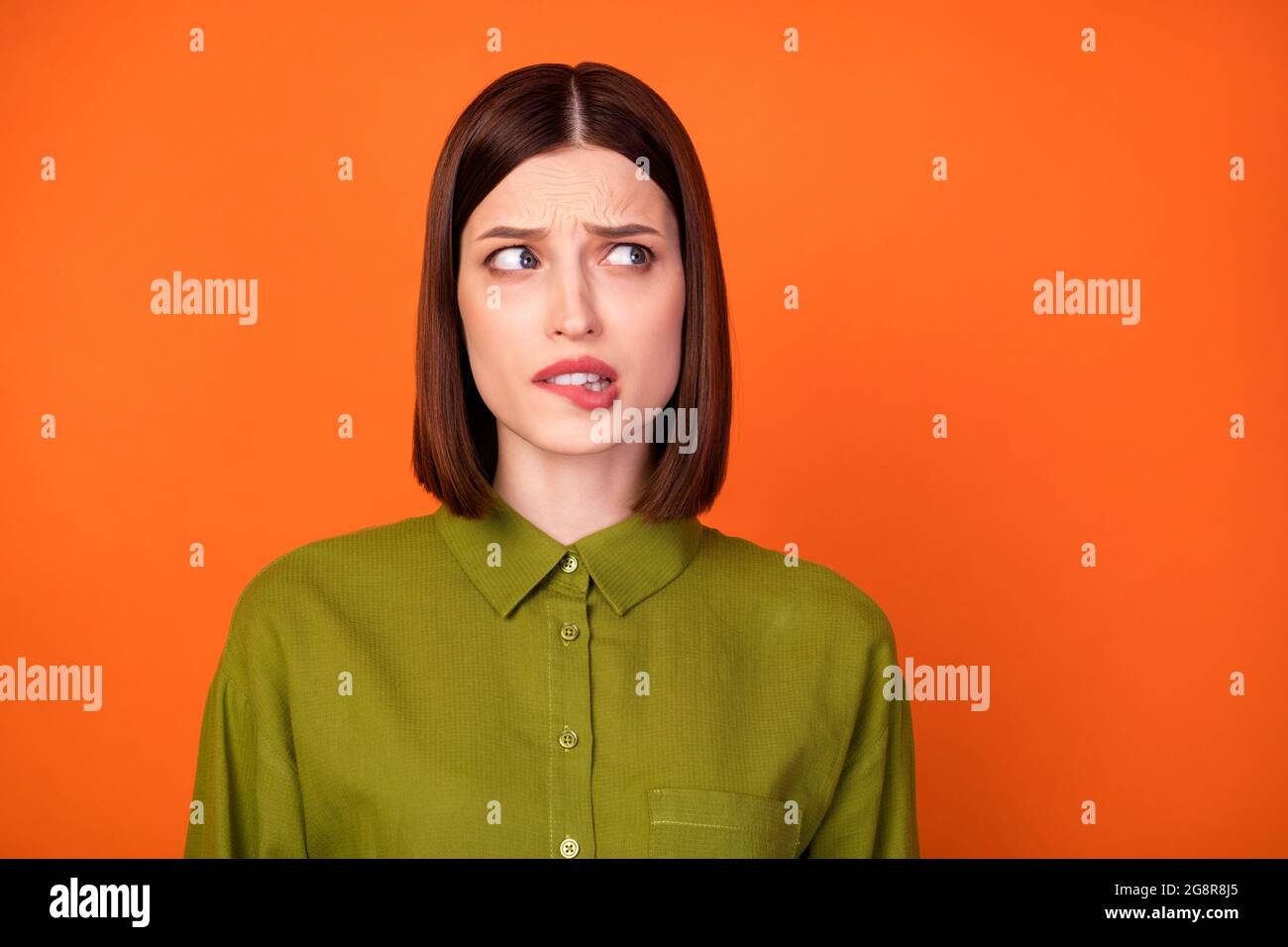 Photo of sad brunette hairdo millennial lady bite lip look empty space ...