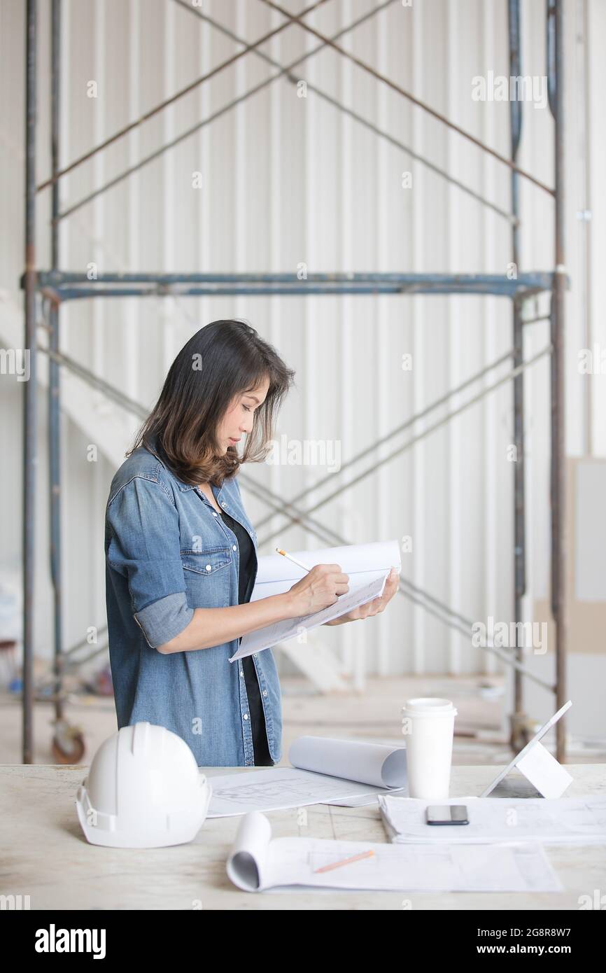 Standing woman in blue shirt hi-res stock photography and images - Alamy