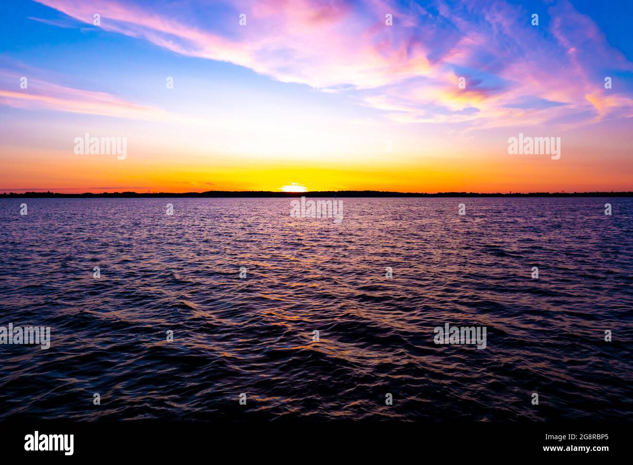 Bright beautiful sunrise or sunset at sea. Stock Photo