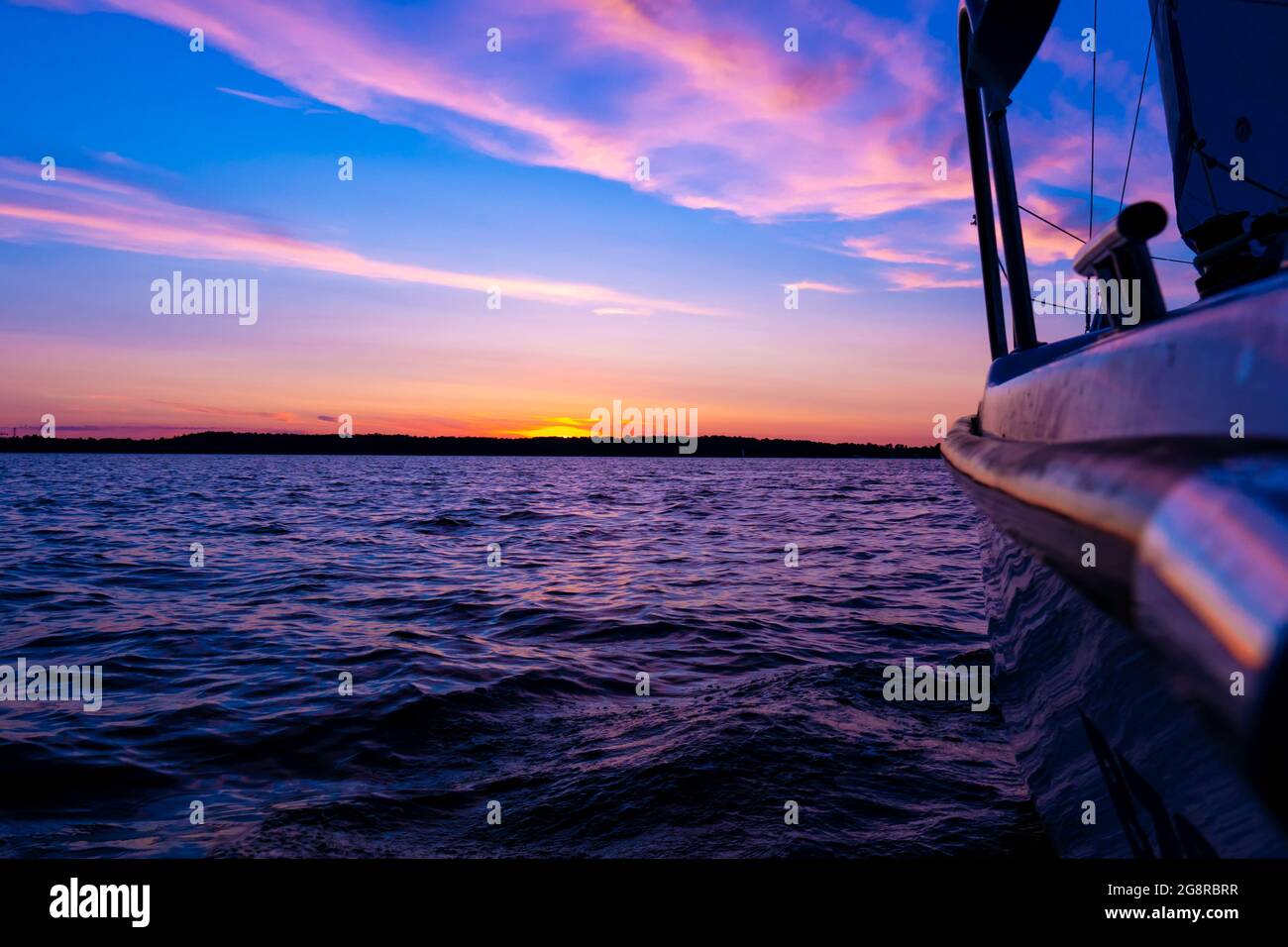 Sailing boat on a calm lake with reflection in the water. Serene scene ...