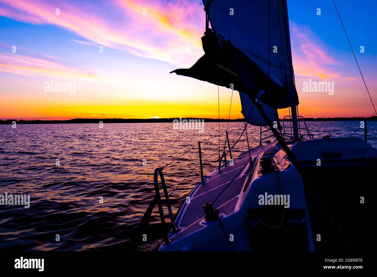 Sailing boat on a calm lake with reflection in the water. Serene scene ...