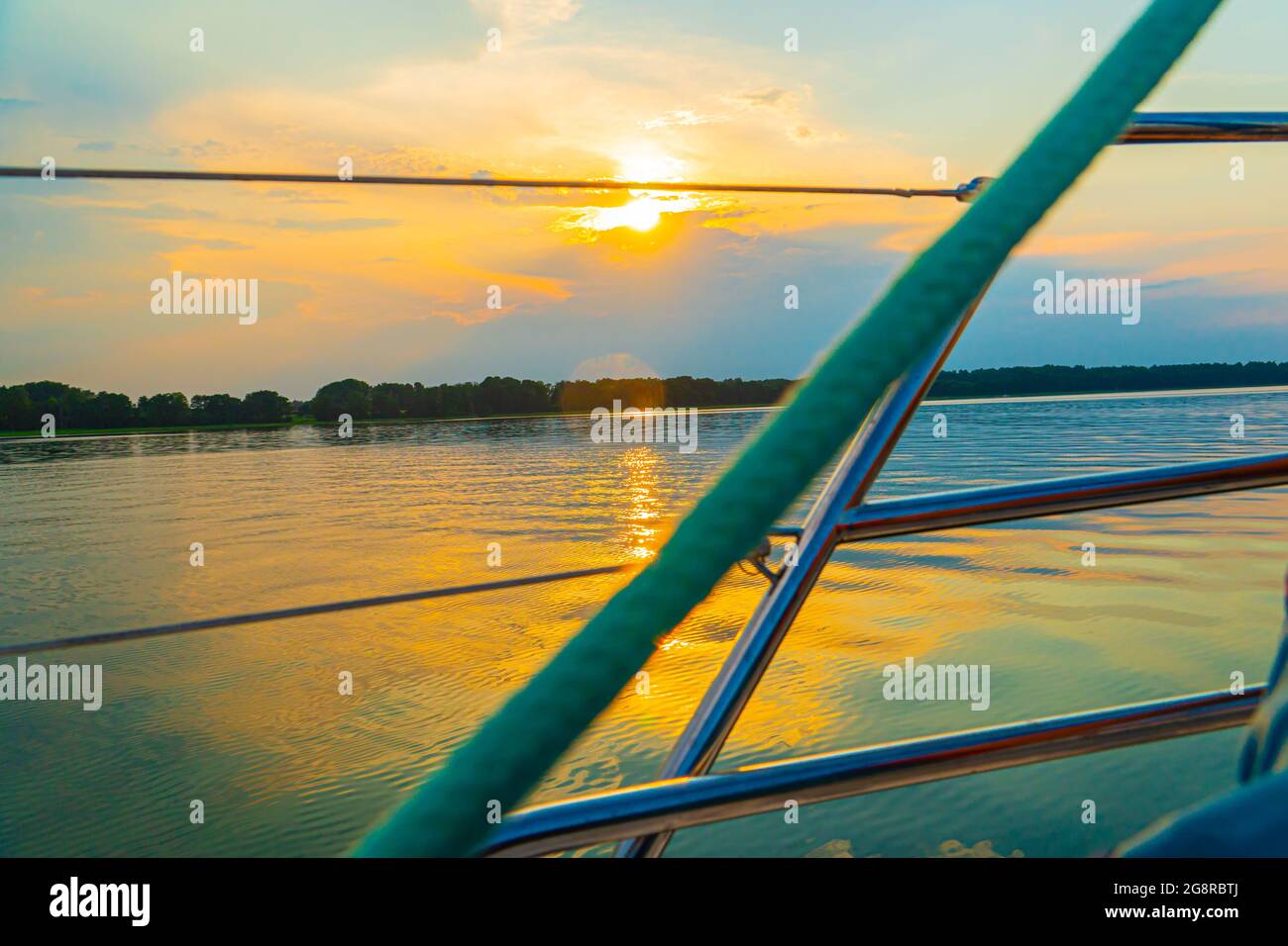Sailing boat on a calm lake with reflection in the water. Serene scene ...