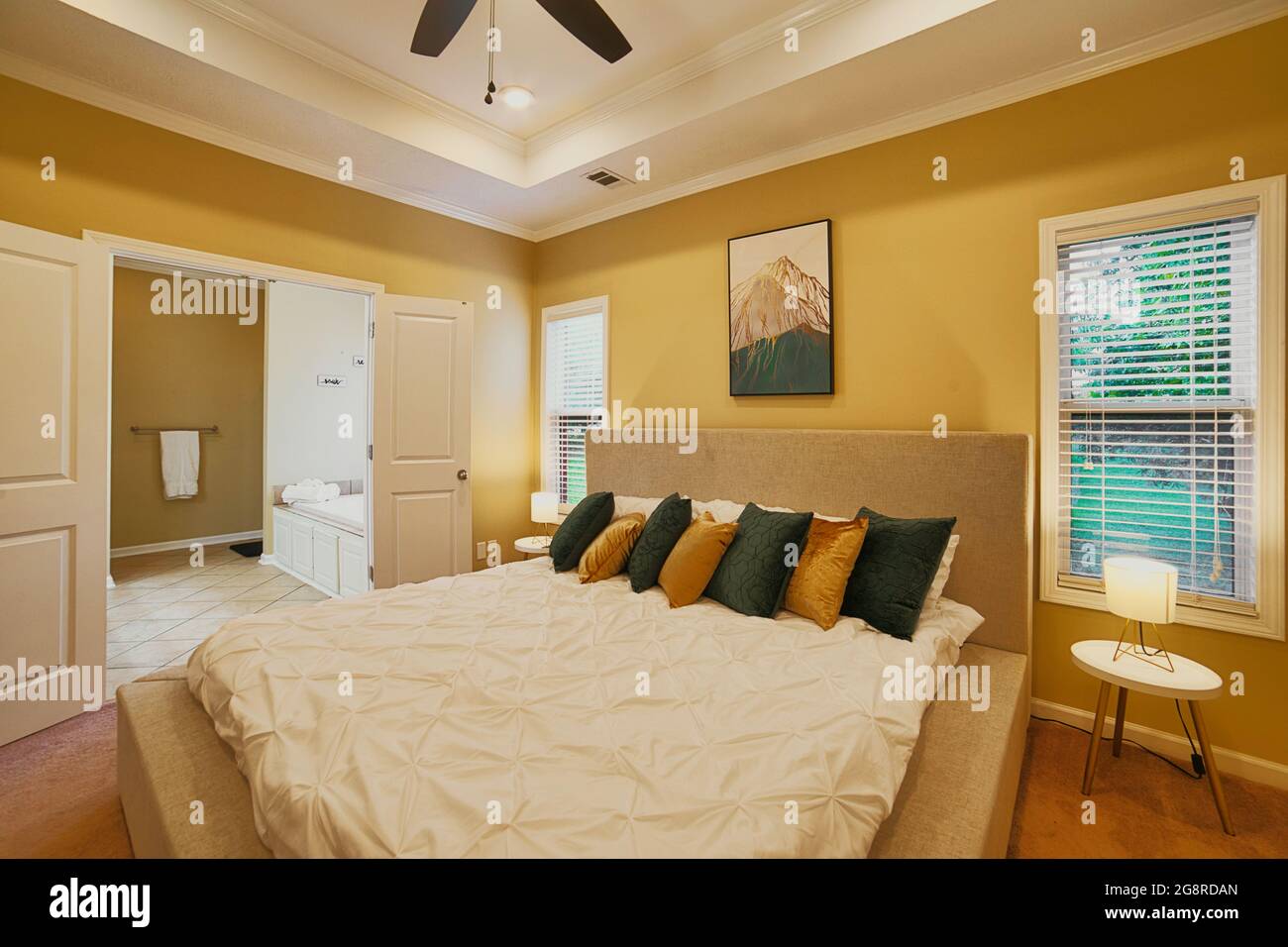 An inviting and comfortable master bedroom and en suite. Why stay at a hotel when you get this much comfort with a vacation rental. Stock Photo