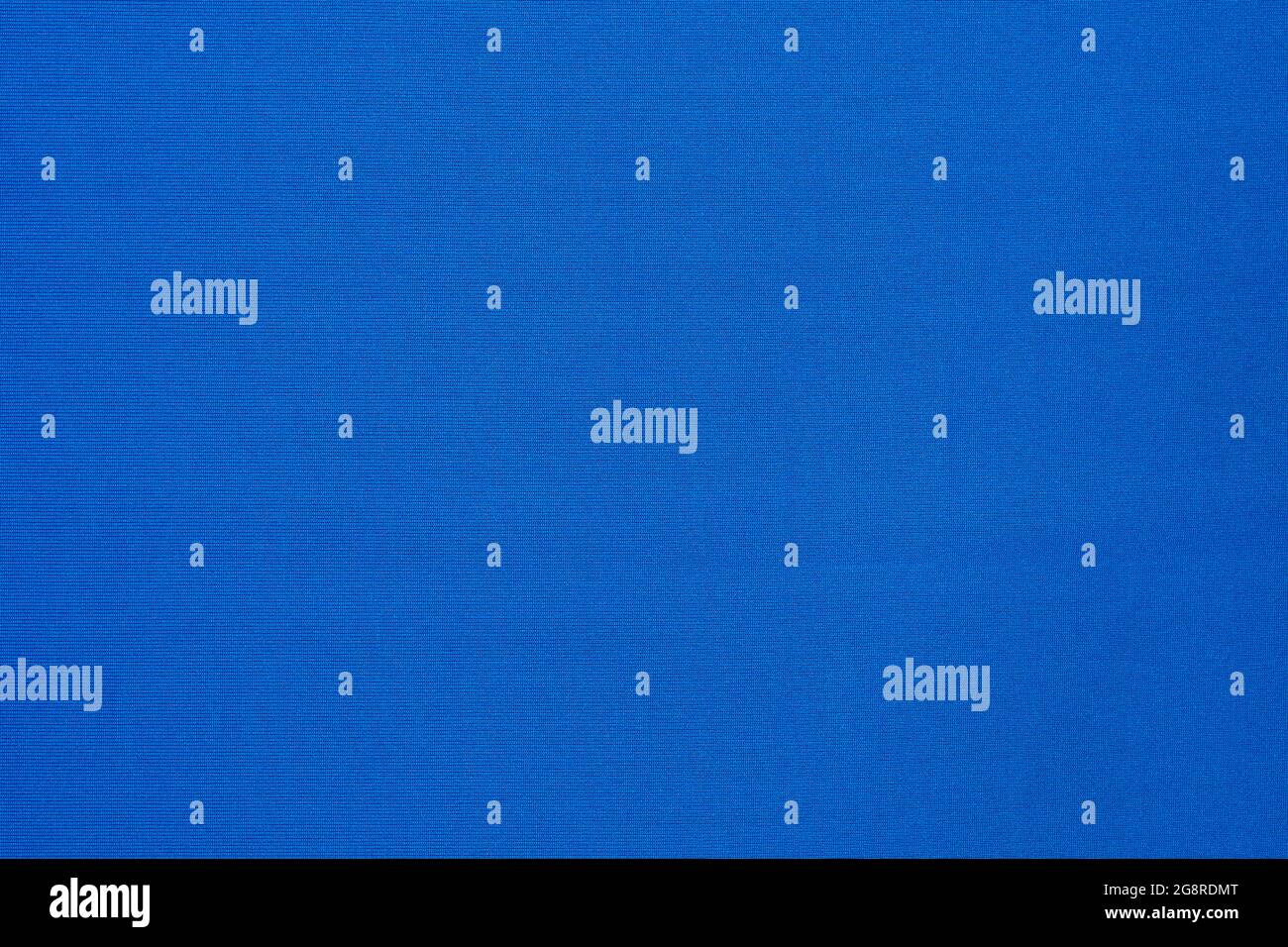 Texture of vibrant light blue flat fabric made of polyester material. Fabric background in light blue tone. Stock Photo