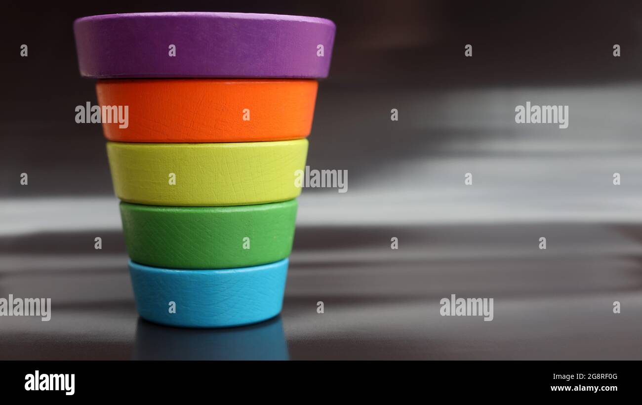 inverted multicolor child's pyramid on black background Stock Photo