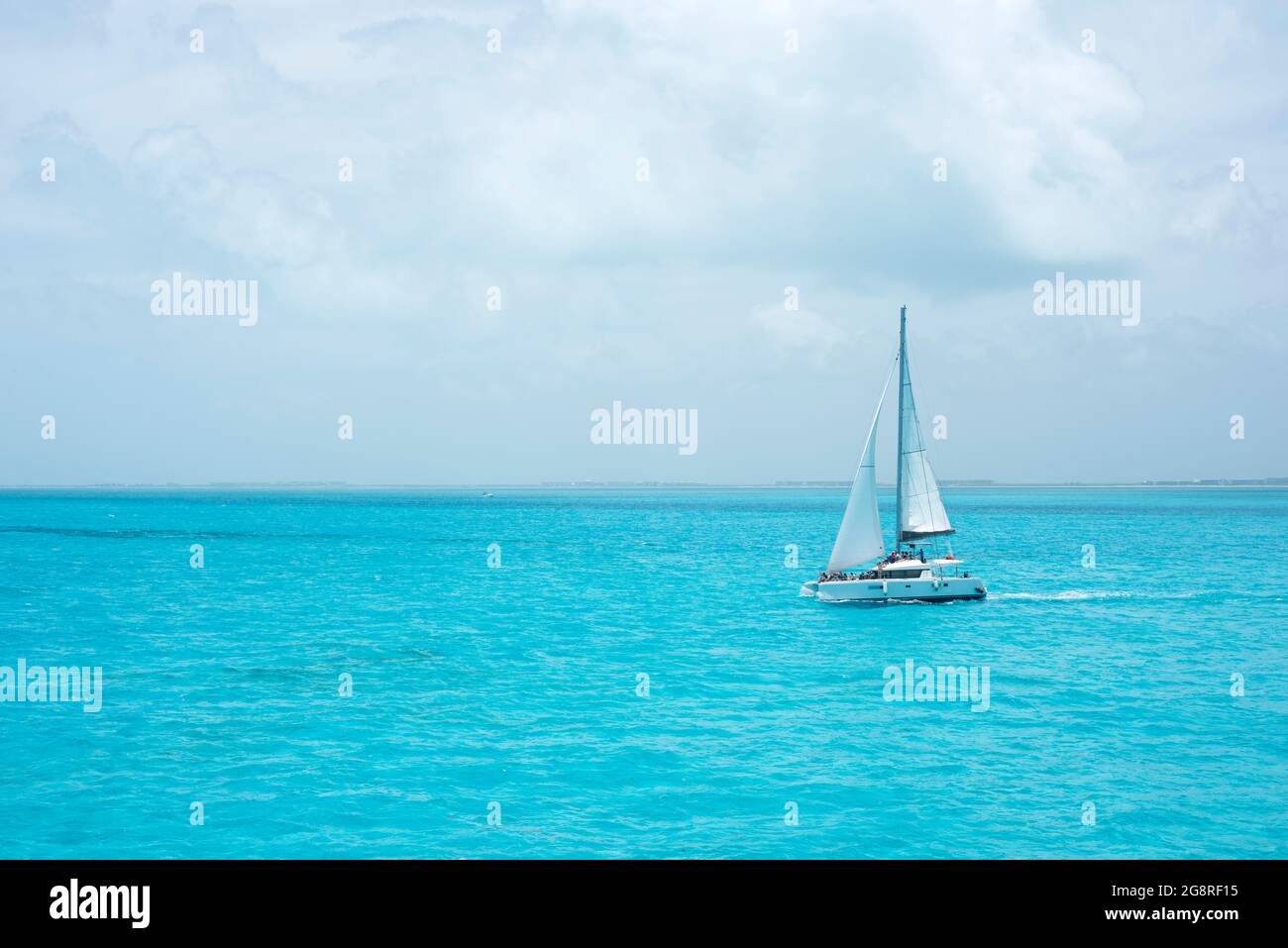 A luxury catamaran with some tourists sailing in the ocean of the