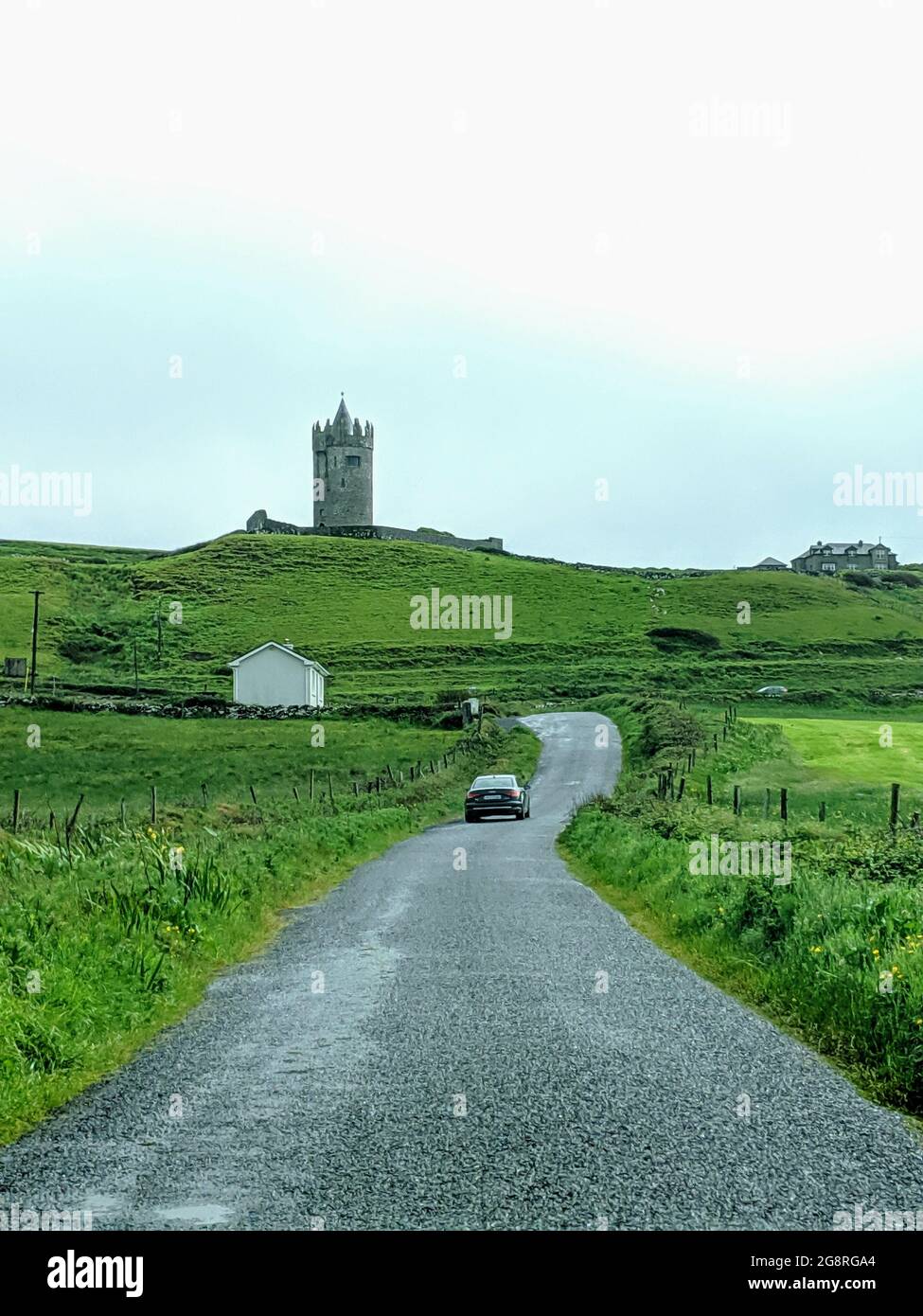 Road leading to a beautiful castle in Doolin village on Ireland’s west coast Stock Photo