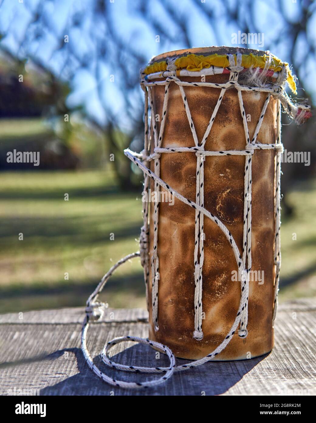 Bongo drum in a park. Traditional musical instrument, isolated blurred background. vertical Stock Photo