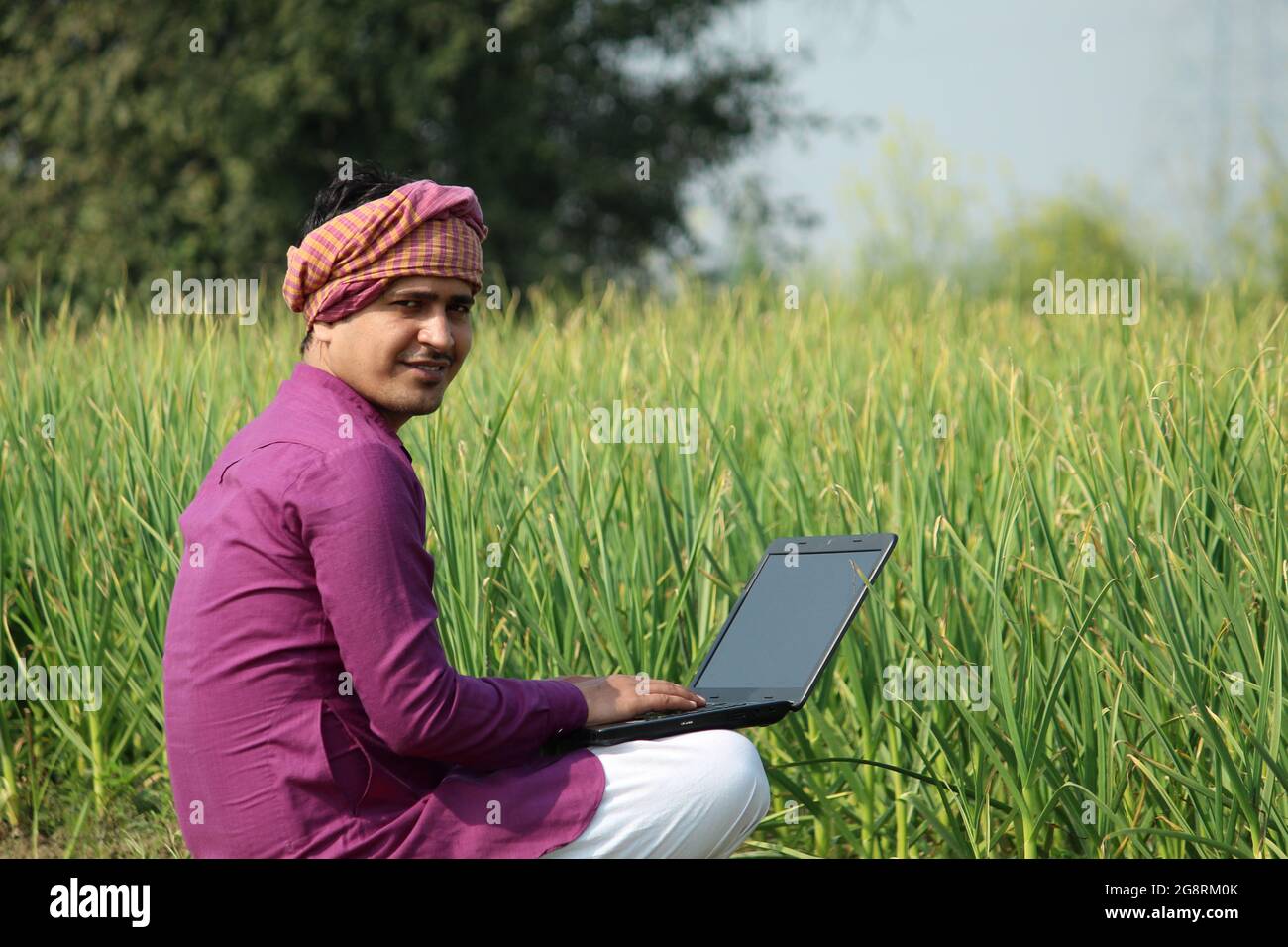 farmer,indian farmer,using laptop in agricultural field Stock Photo