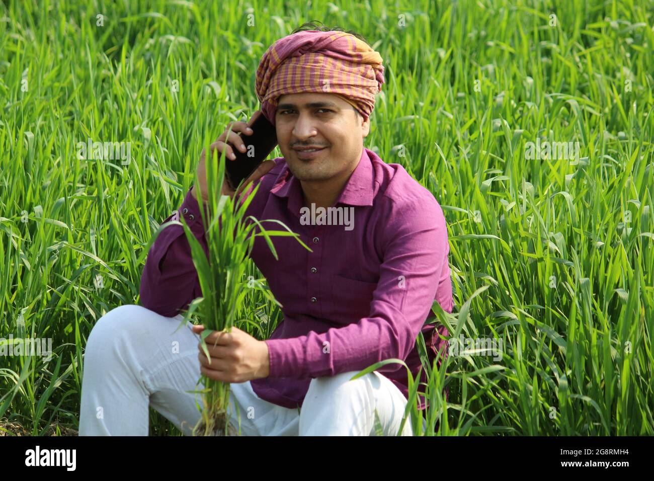 indian farmer talking phone,agricultral field Stock Photo