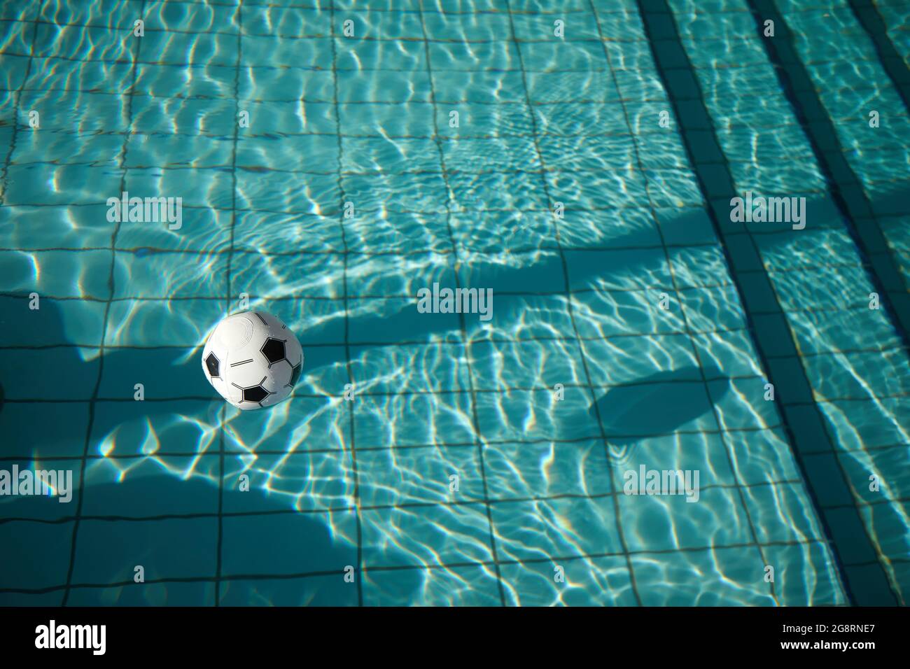 Beach ball in pool. Inflatable ball floating in swimming pool Stock ...