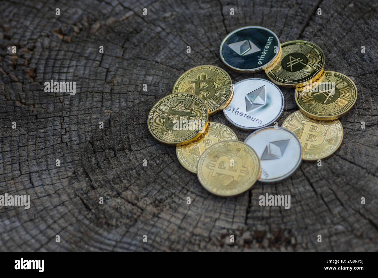many valueable golden and silver coins bitcoin ether and ada from  cryptocurrency lying on a white gravel Stock Photo - Alamy