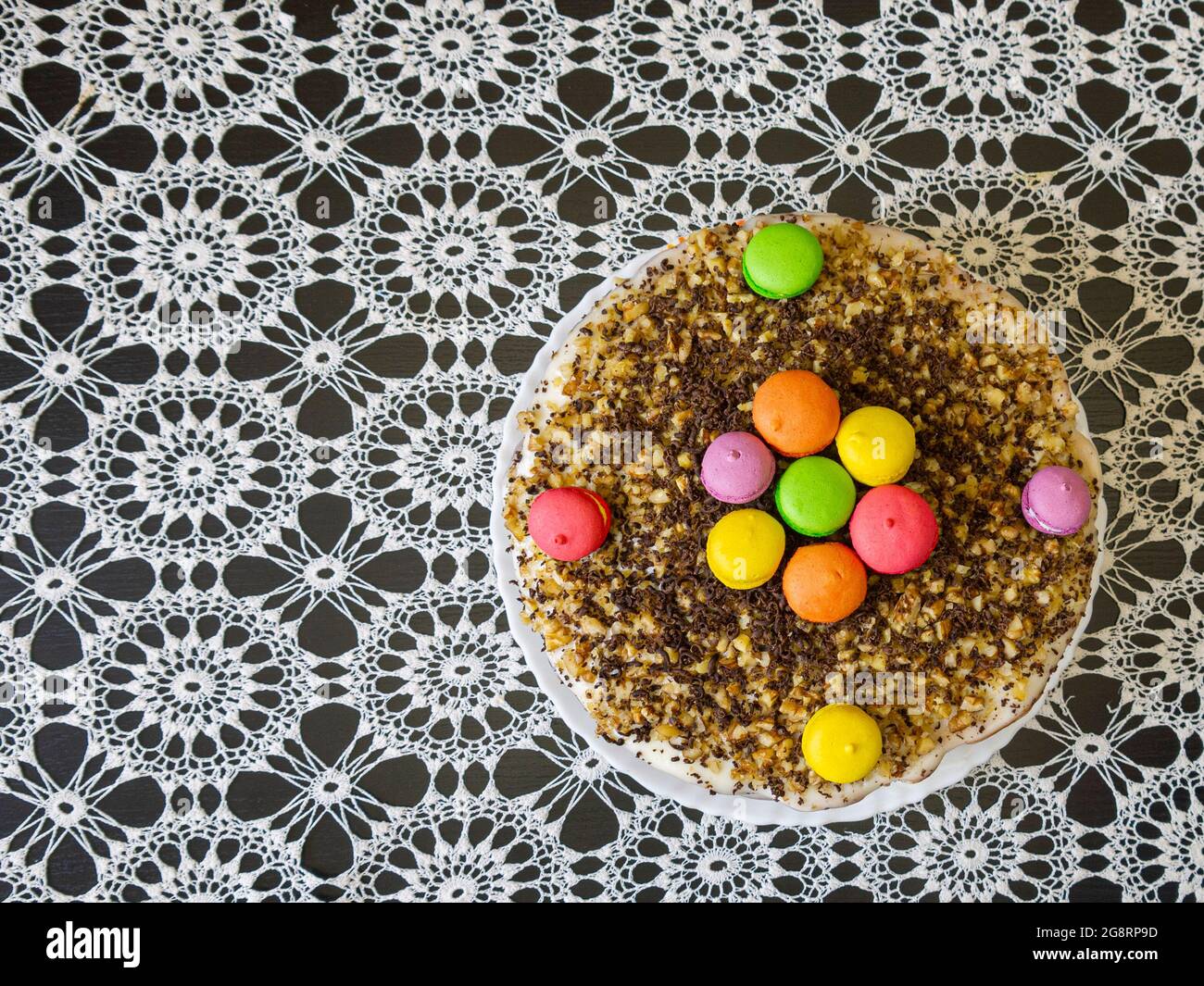 Home-made cake on a table covered with a beautiful tablecloth. The concept of making culinary products with family members. Stock Photo