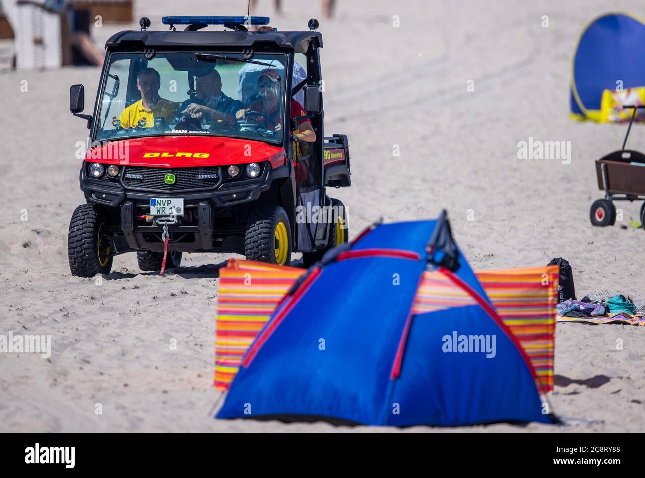 Prerow, Germany. 15th July, 2021. With a special rescue vehicle of the type Gator, lifeguards of the DLRG are on duty at the Baltic Sea beach. Credit: Jens Büttner/dpa-Zentralbild/ZB/dpa/Alamy Live News Stock Photo