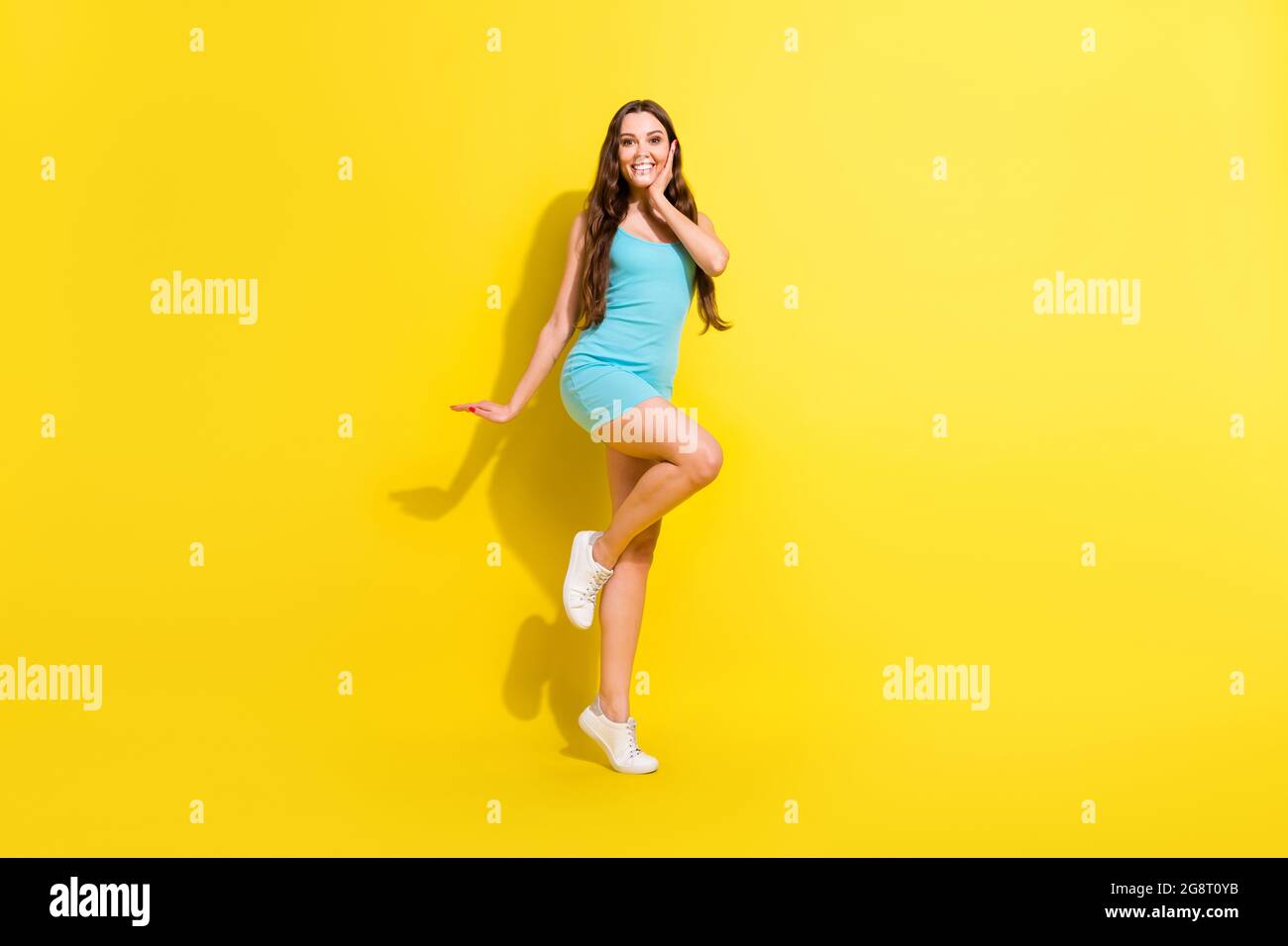 Full length body size view of attractive amazed cheerful girl dancing having fun posing isolated over bright yellow color background Stock Photo