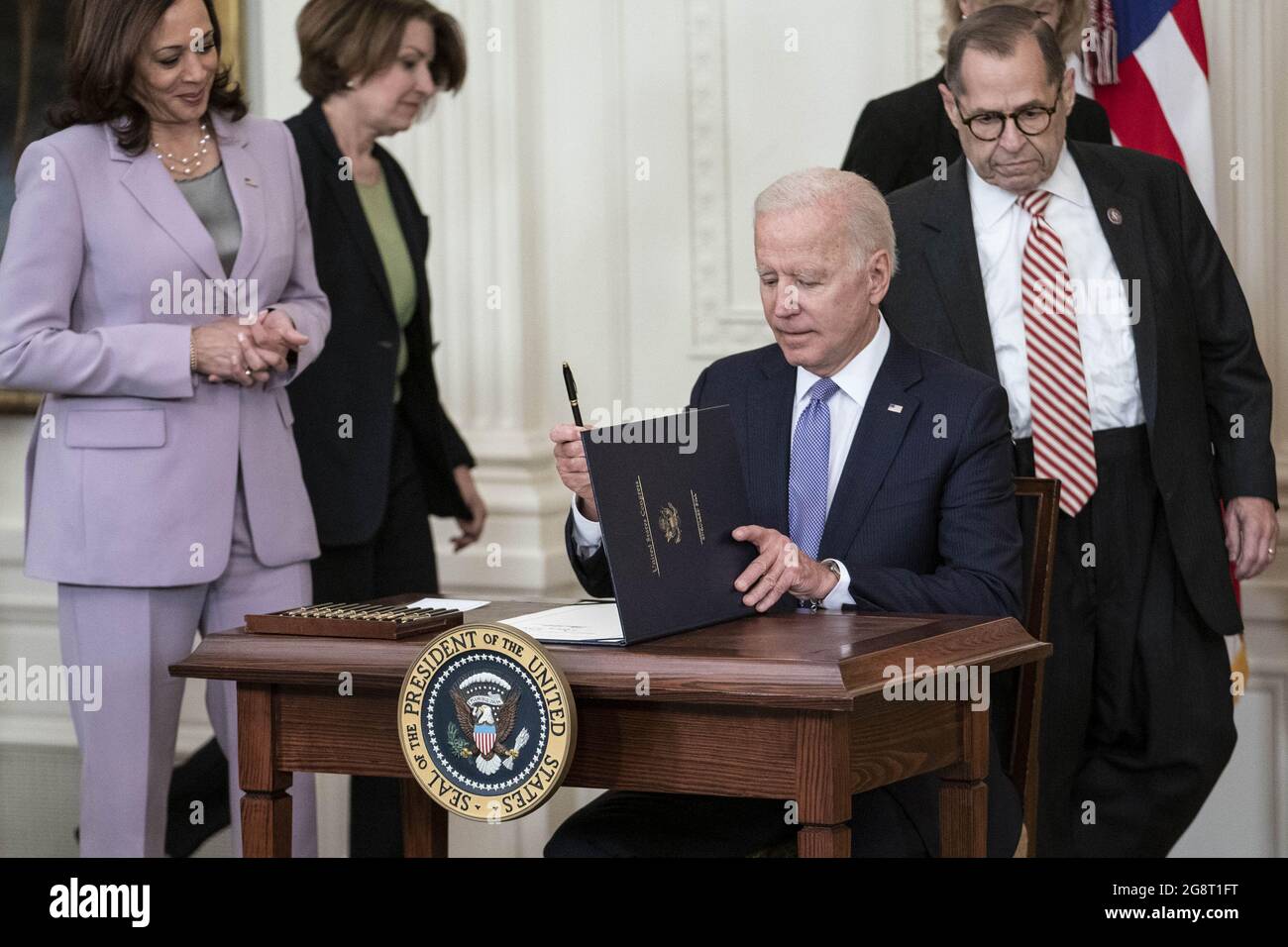 Washington, United States. 22nd July, 2021. President Joe Biden prepares to sign H.R. 1652, the VOCA Fix to Sustain the Crime Victims Fund Act of 2021, into law in the East Room of the White House in Washington, DC on Thursday, July 22, 2021. President Biden was joined by a bipartisan bicameral group of lawmakers. Photo by Sarah Silbiger/UPI Credit: UPI/Alamy Live News Stock Photo