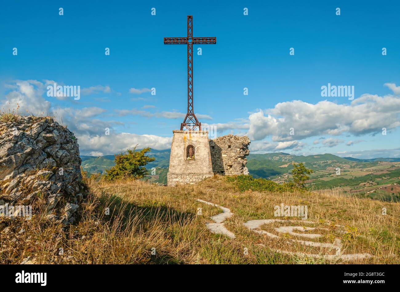 Cross on top of the Roccione of Pennabilli in Emilia Romagna, North Italy Stock Photo