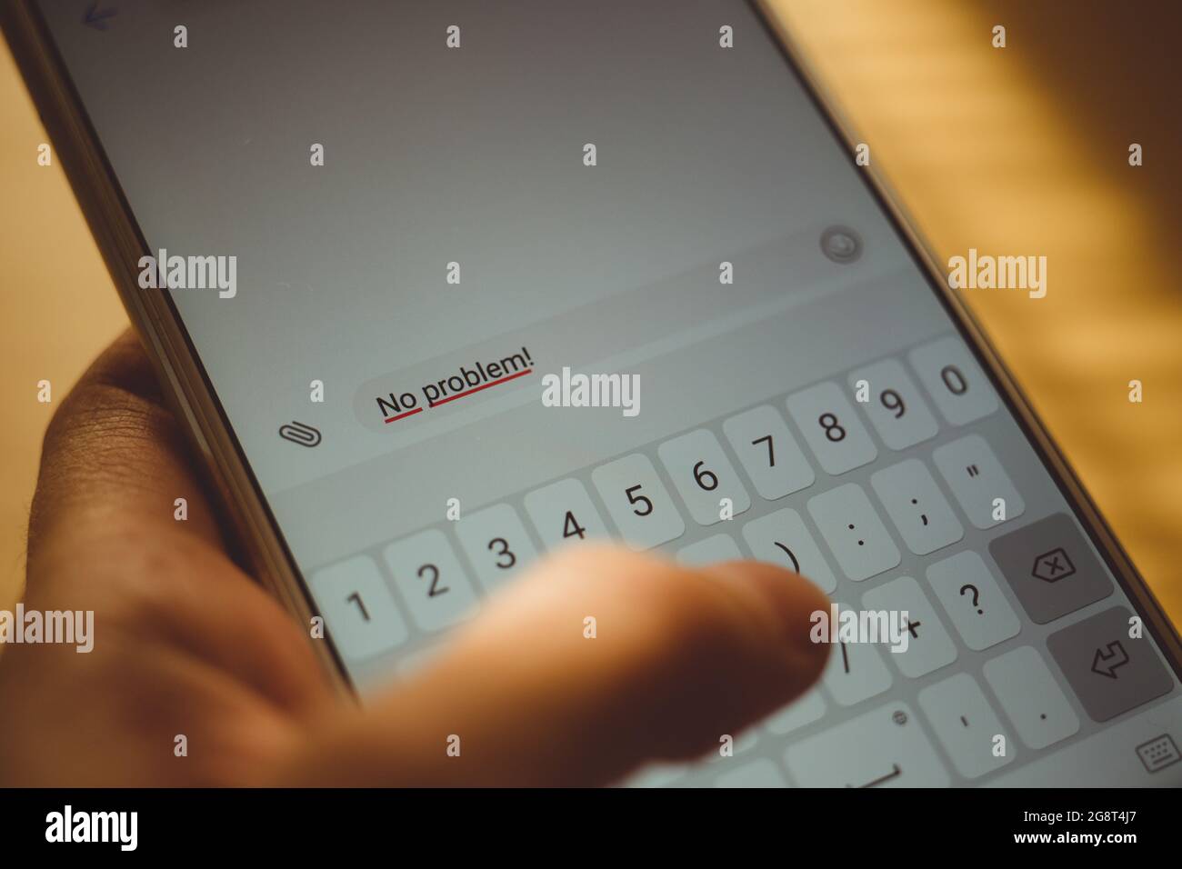 Human hand typing on a smartphone screen a message No problem Stock Photo