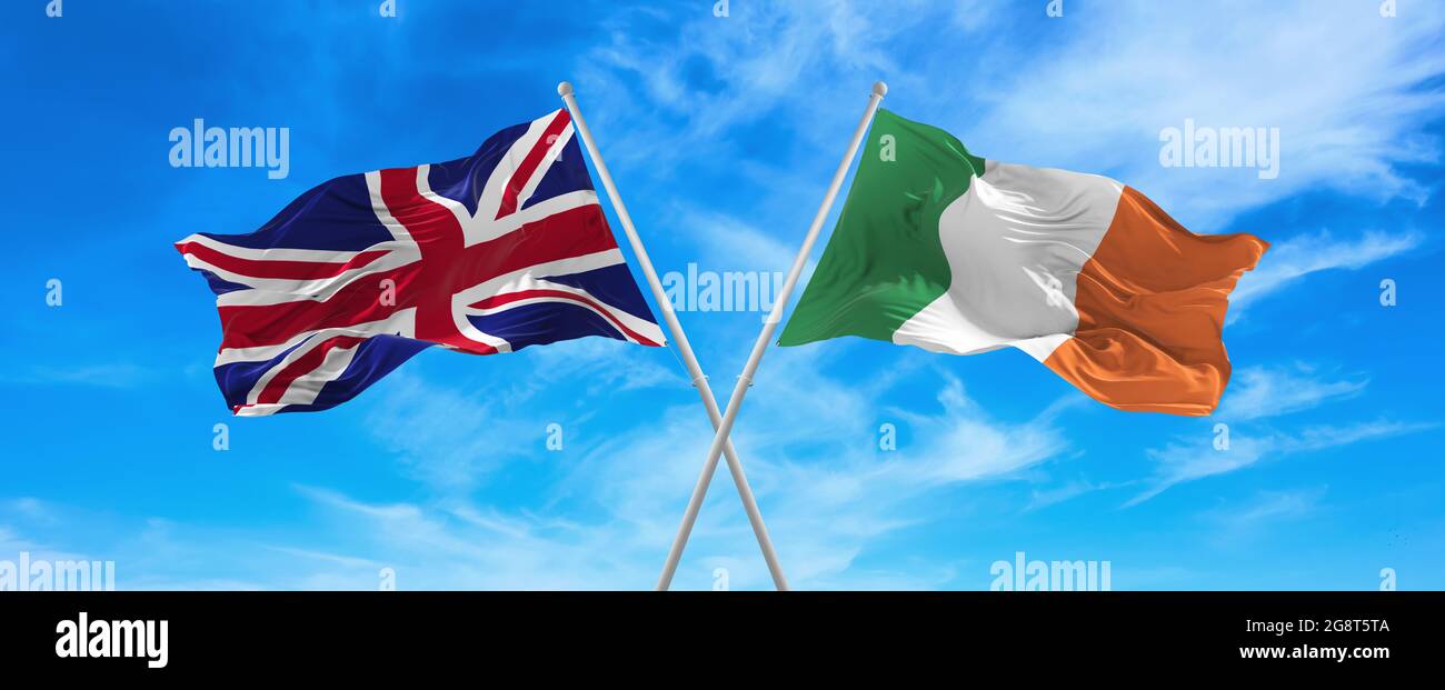 flags of great Britain and Ireland waving in the wind on flagpoles ...