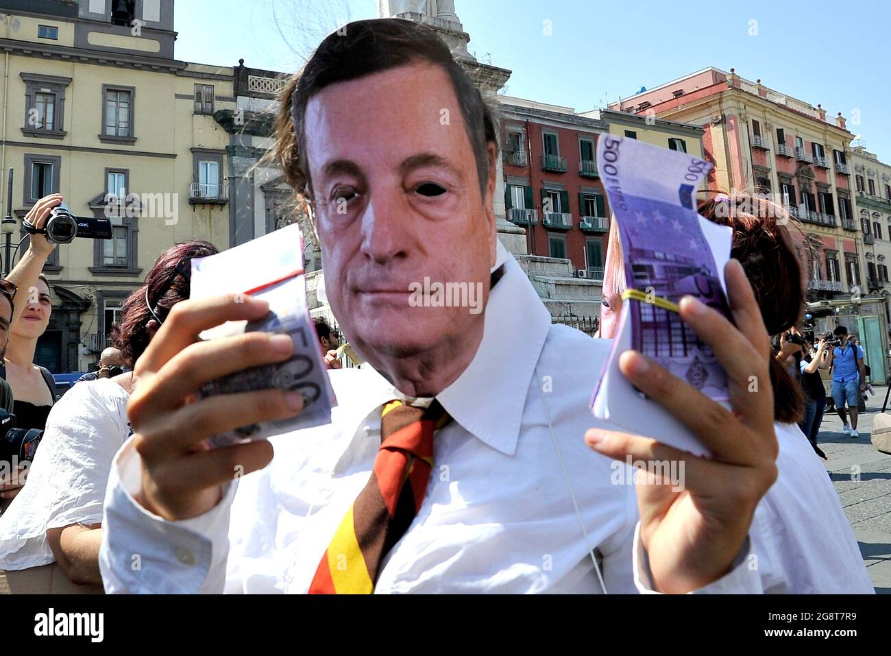 Naples, Italy. 22nd July, 2021. Protester with a mask depicting the president of Italy Mario Draghi with a bunch of money in his hands, during the demonstration against the G20 environment which was held in Naples, Italy on July 22, 2021. The G20 is held from July 22-23, 2021. (photo by Vincenzo Izzo/Sipa USA) Credit: Sipa USA/Alamy Live News Stock Photo