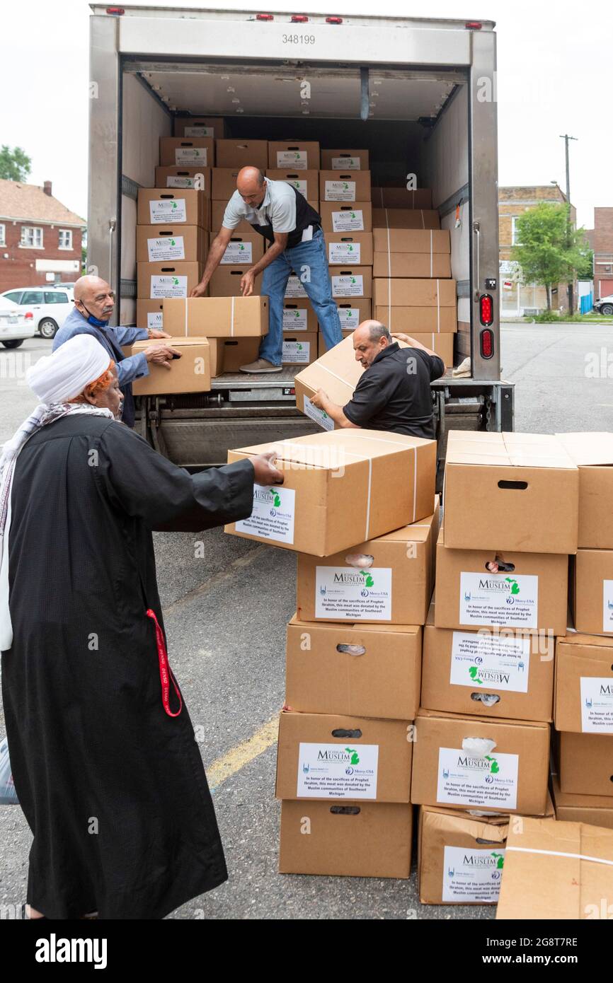 Detroit, Michigan, USA. 22nd July, 2021. Members of the Michigan Muslim Community Council unload packages of lamb for distribution to the poor during the Eid al-Adha holiday. Eid al-Adha commemorates the story, common to Muslims and Christians, in which God asked Ibrahim (Abraham) to sacrifice his son, but at the last minute substituted a lamb instead. During the holiday Muslims butcher a lamb, keeping part of the meat and donating the rest to anyone in need. Credit: Jim West/Alamy Live News Stock Photo