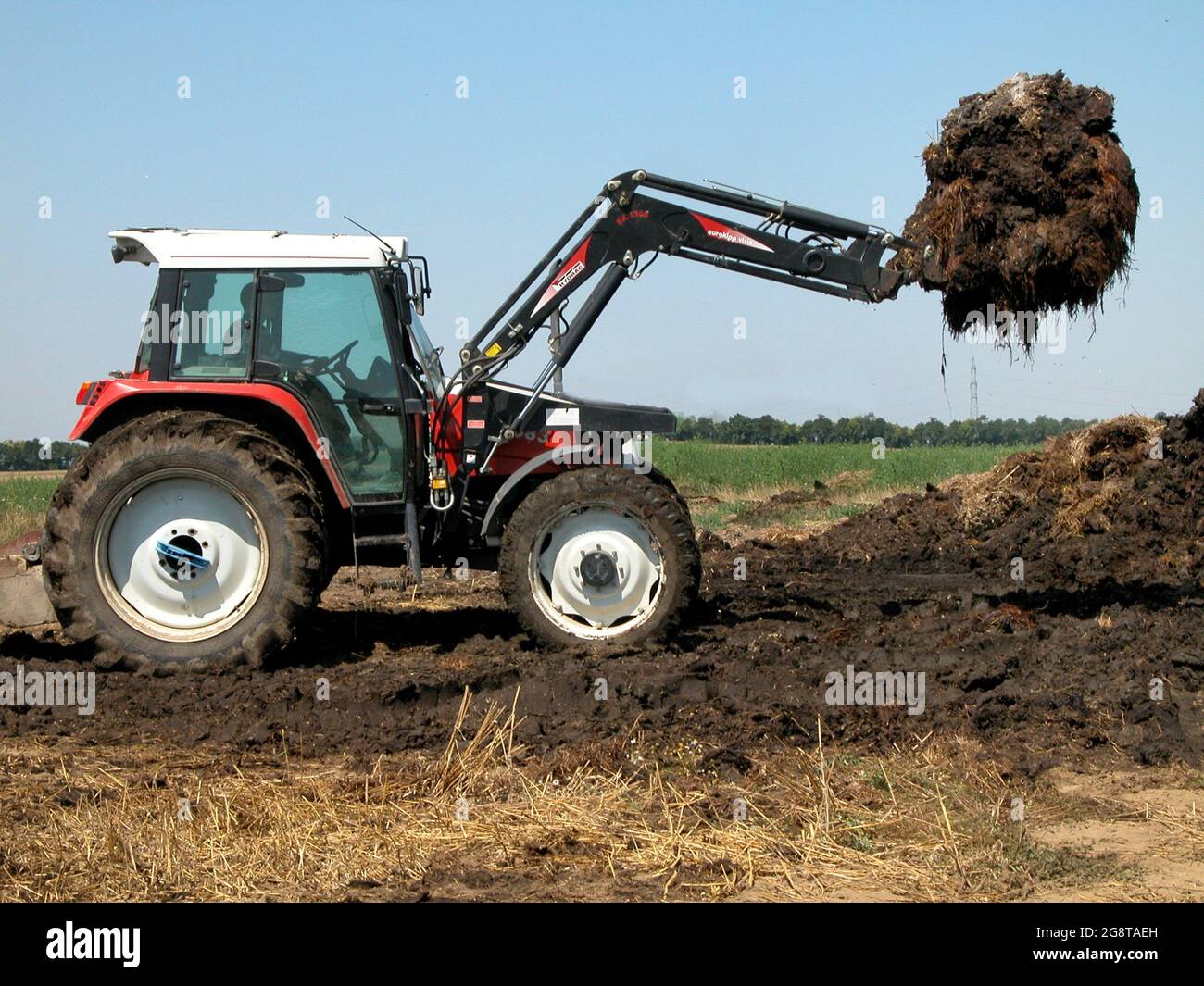 Tractor with loading fork hires stock photography and images Alamy