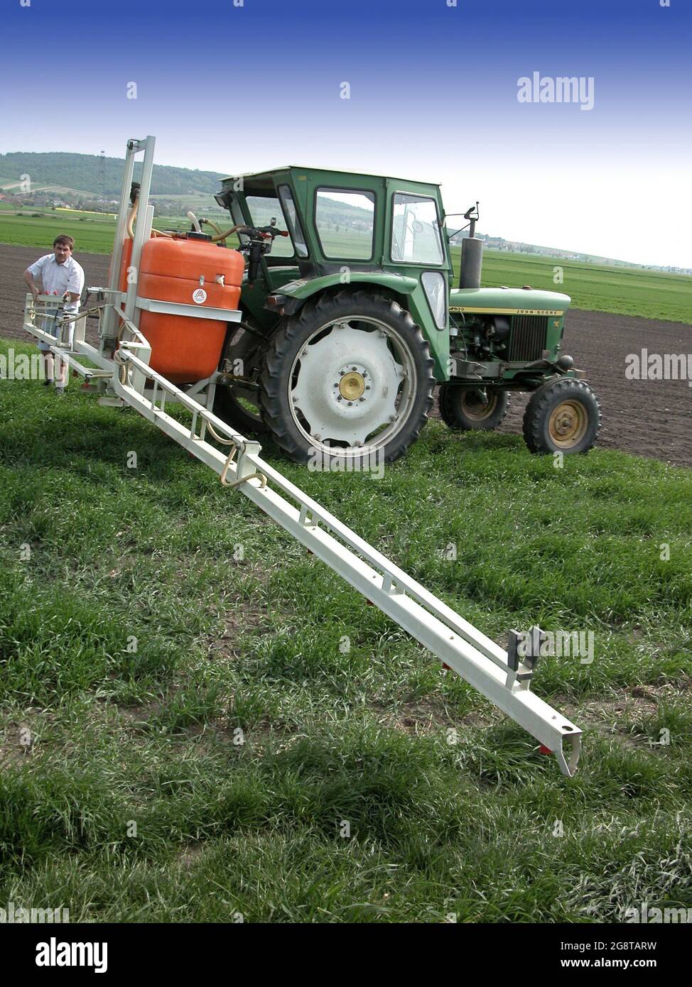 armer with tractor and field sprayer , Austria, Lower Austria Stock Photo