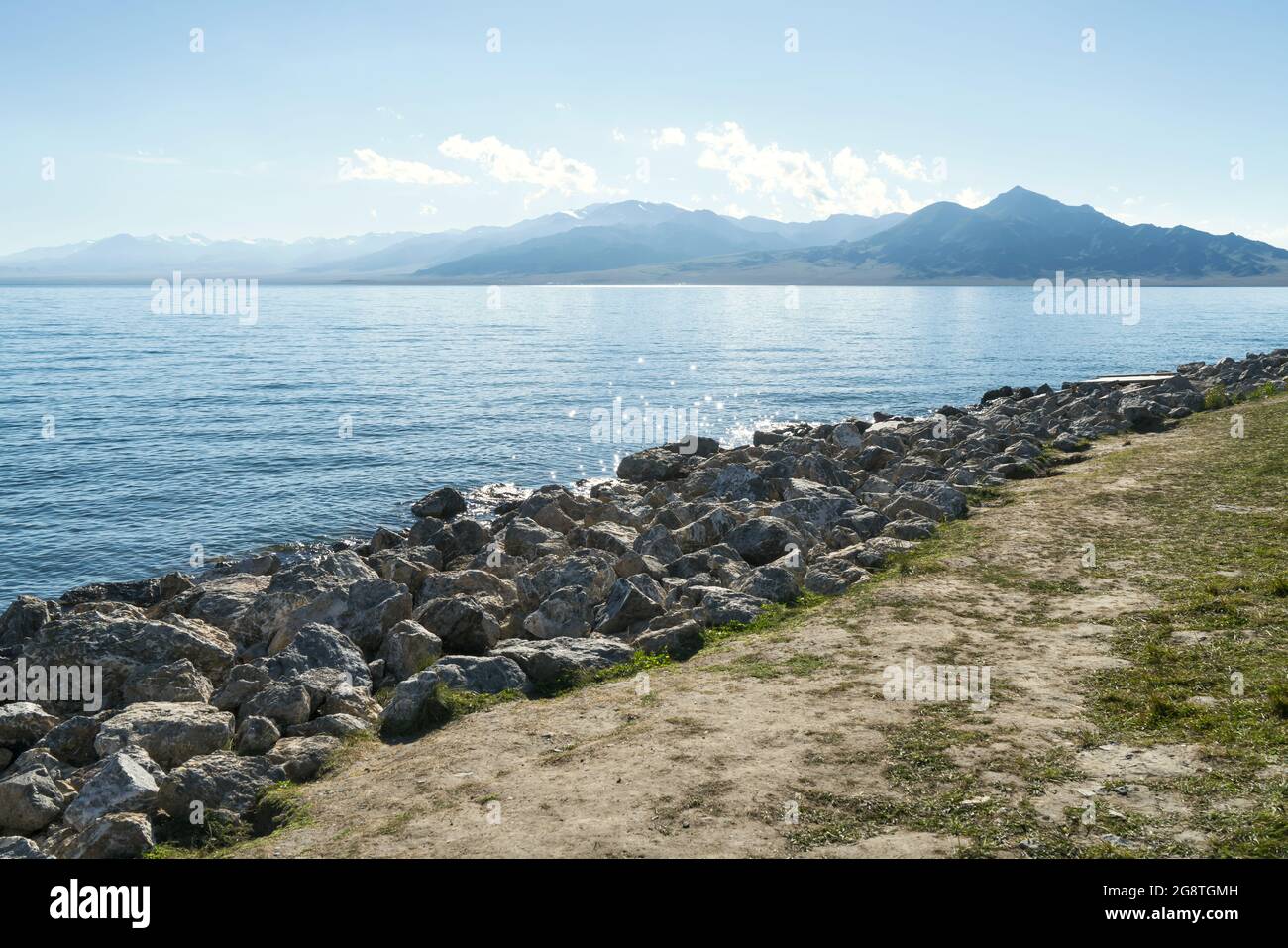 The calm surface of the lake and rocks. Shot in Sayram Lake, Xinjiang, China. Stock Photo