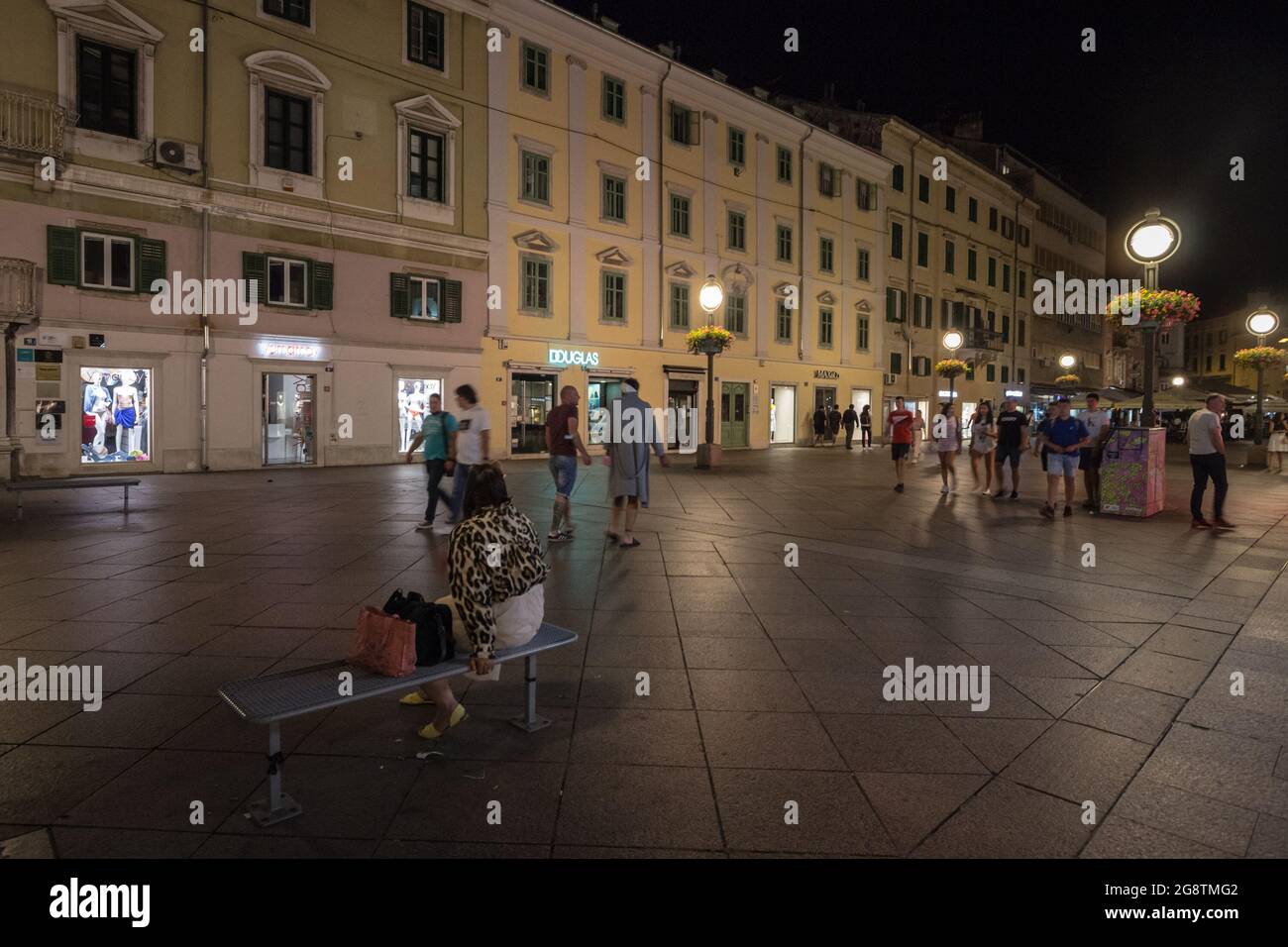 Picture of Rijeka at night with pedestrians passing by the street of Korzo, the main pedestrain way of Rijeka, croatia. Stock Photo