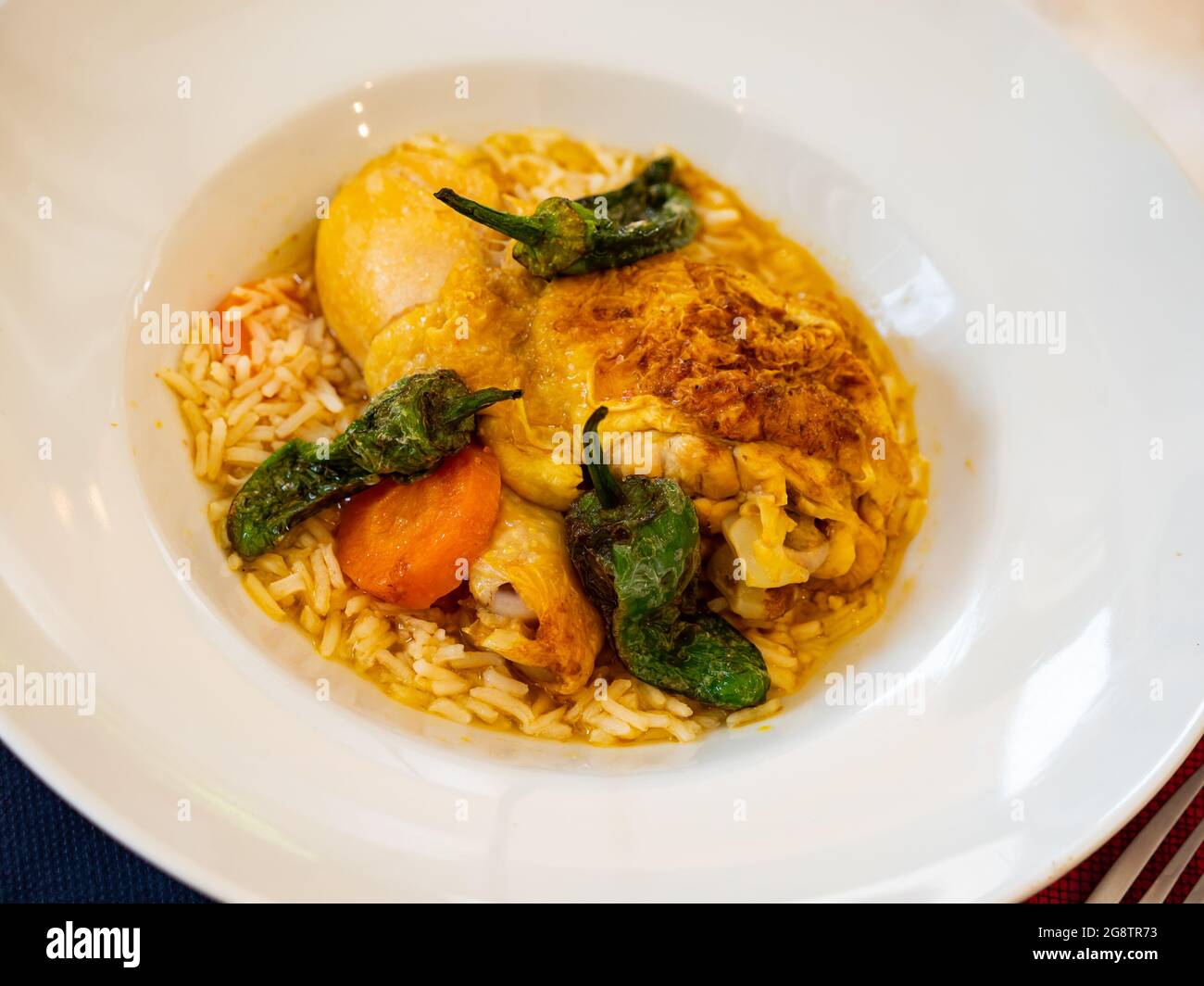 Traditional French cuisine, chicken thigh curry with rice Stock Photo