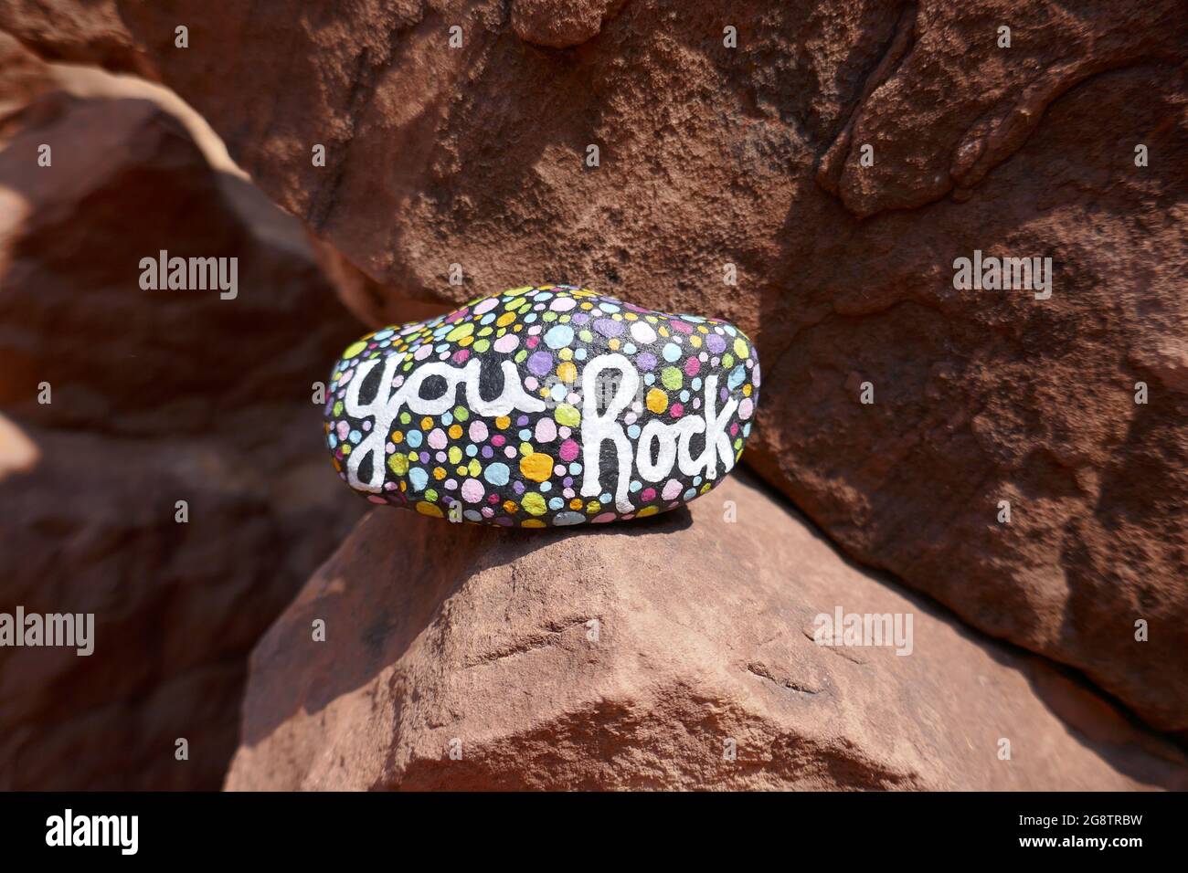 Kindness rock with painted you rock message balanced on larger rock Stock Photo