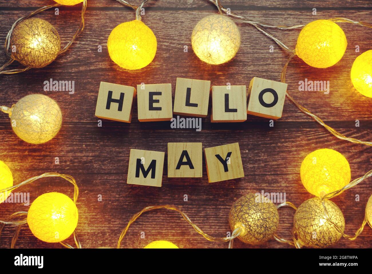 Hello May alphabet letter with LED cotton balls on wooden background ...