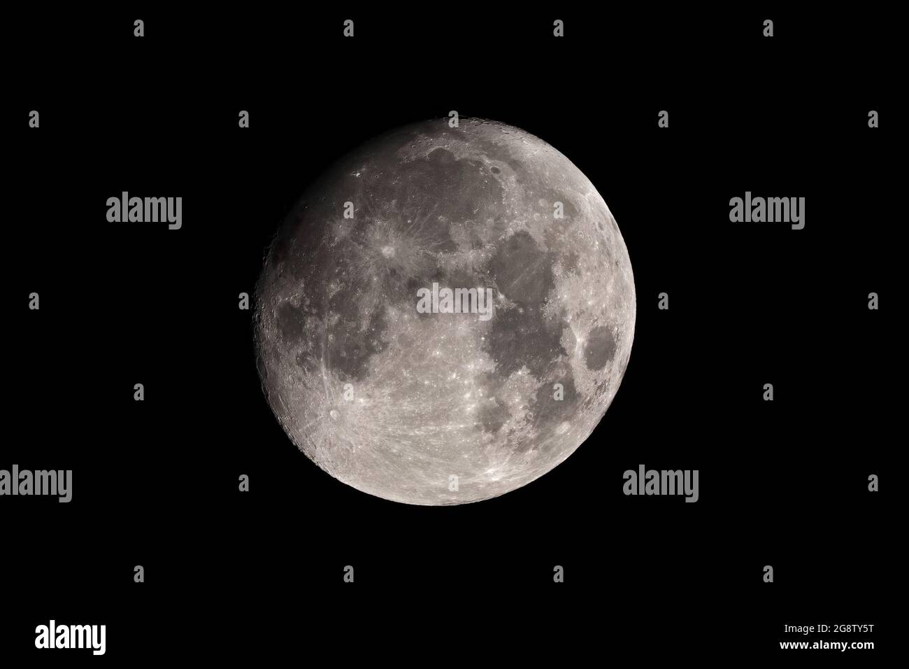 Waxing Gibbous Moon against Dark Sky Stock Photo