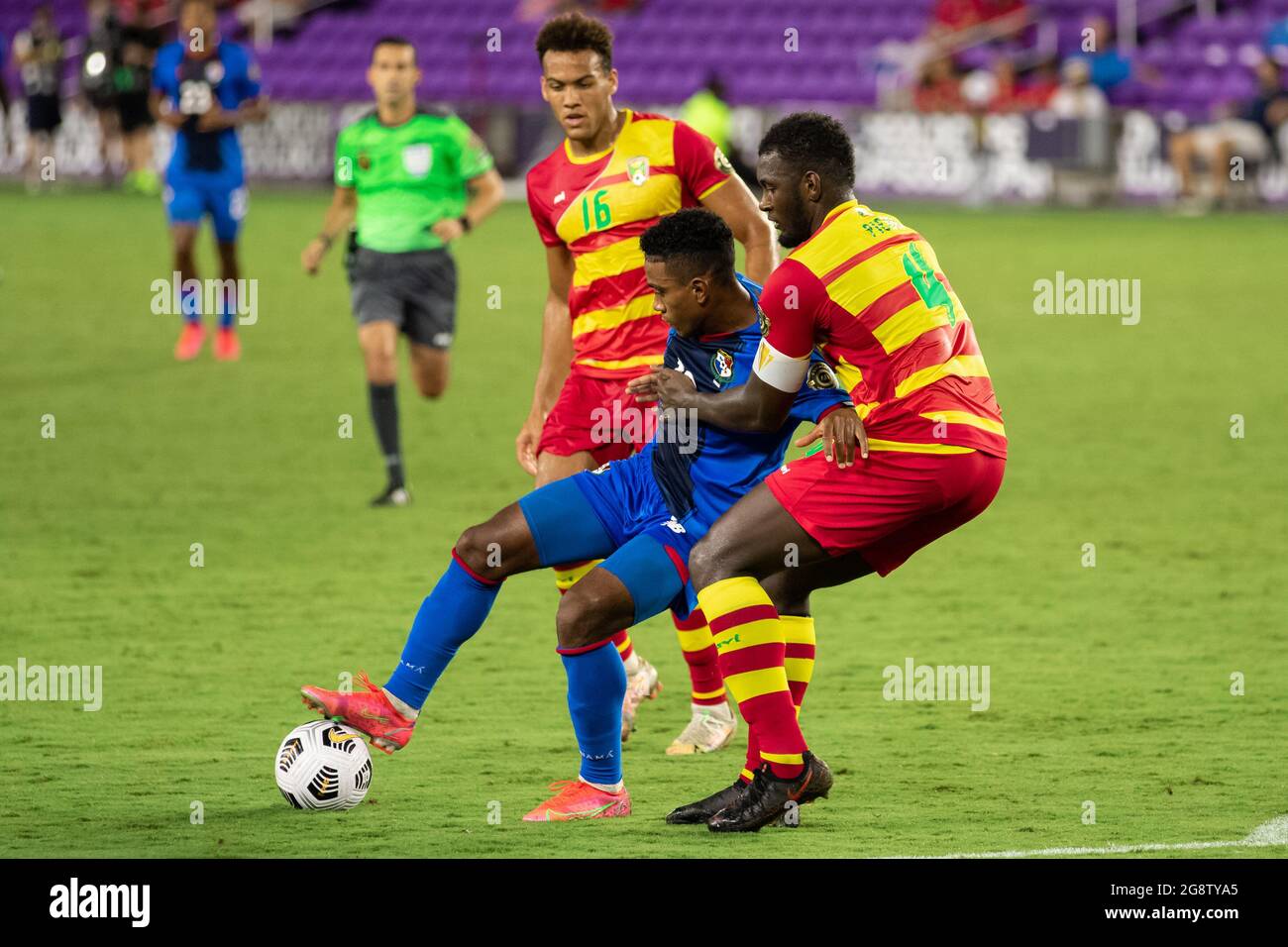 Orlando, United States. 21st July, 2021. Edgar Barcenas /910 Panama) struggles to pass the ball forward as Aaron Pierre (4 Grenada) battles to make a tackle during the CONCACAF Gold Cup game between Panama and Grenada at Exploria Stadium in Orlando, Florida. NO COMMERCIAL USAGE. Credit: SPP Sport Press Photo. /Alamy Live News Stock Photo