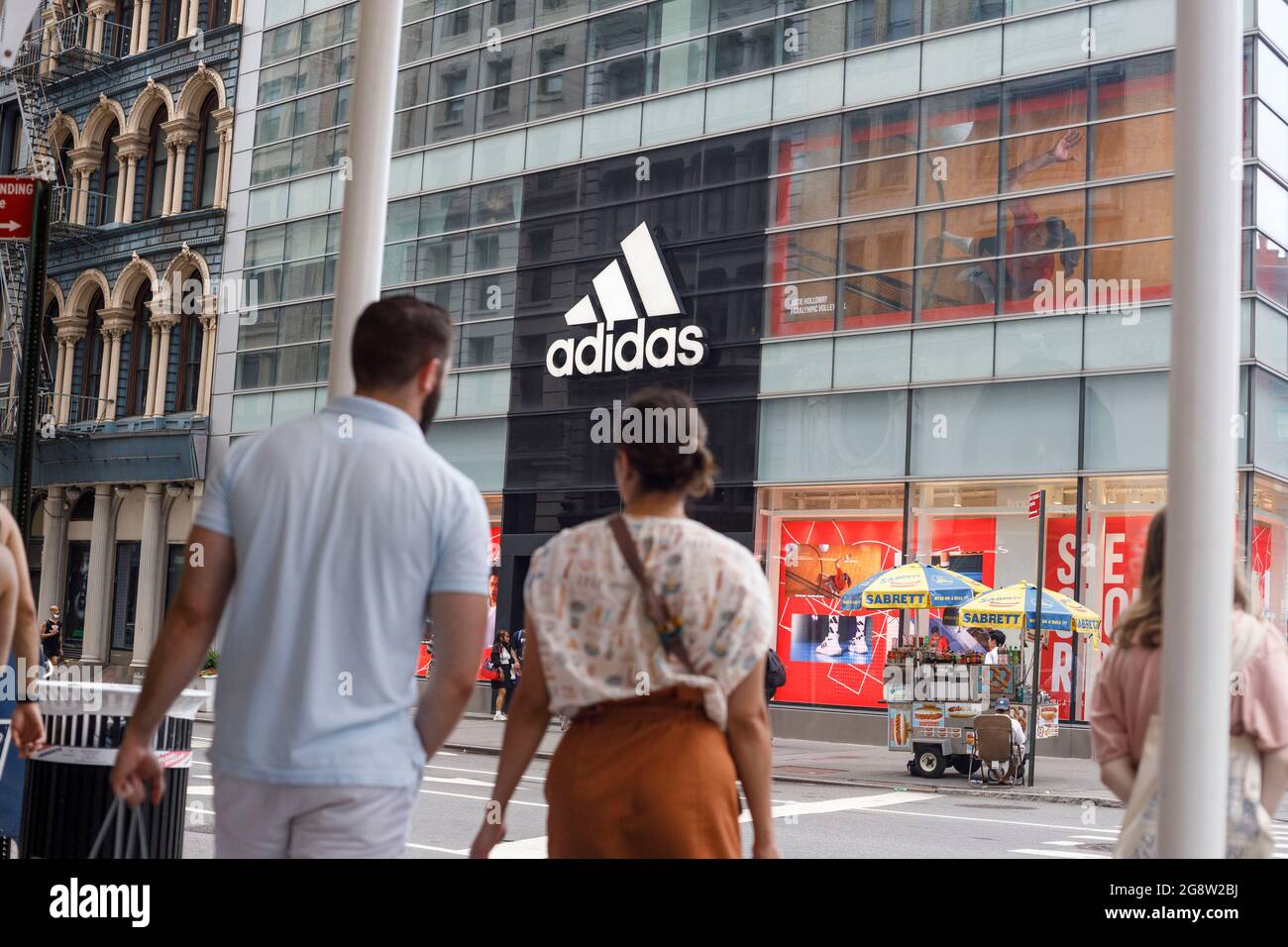 Shoppers walk in front of an Adidas store in Manhattan. (Photo by Stephen  Zenner / SOPA Images/Sipa USA Stock Photo - Alamy