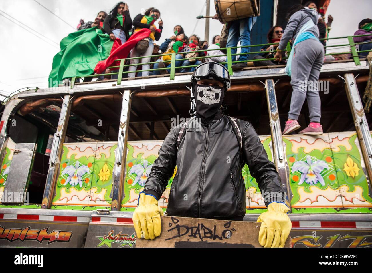 Members of the indigenous guard sit on a traditional bus during the demonstration.The indigenous guard arrives in Bogotá on July 20th, Colombia's Independence Day, to support the protests. The day began with a press conference in front of the CRIC (Cauca Regional Indigenous Council), where also members of the frontline participated, during the day two traditional buses, that the indigenous groups used for transport drove all over the resistance points of the capital, where the protests were taking place. Credit: SOPA Images Limited/Alamy Live News Stock Photo