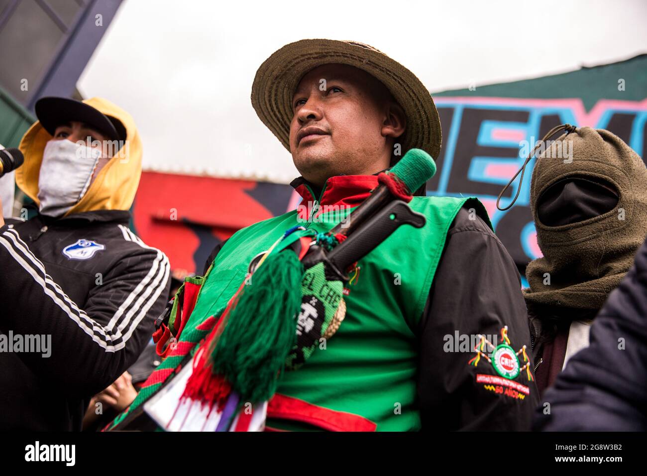 Representative of the indigenous guard together with members of the front line are seen during the rally.The indigenous guard arrives in Bogotá on July 20th, Colombia's Independence Day, to support the protests. The day began with a press conference in front of the CRIC (Cauca Regional Indigenous Council), where also members of the frontline participated, during the day two traditional buses, that the indigenous groups used for transport drove all over the resistance points of the capital, where the protests were taking place. (Photo by Antonio Cascio/SOPA Images/Sipa USA) Stock Photo