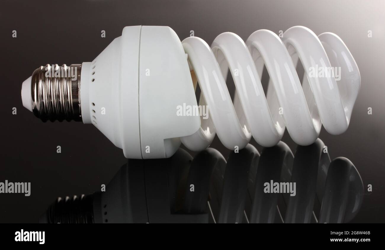 energy saving light bulb on black background Stock Photo - Alamy