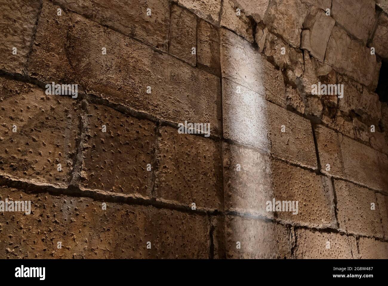 Pillars sticking out of the wall inside a Second Temple period (516 BC-AD 70) public building, that has ever been uncovered outside the Temple Mount walls on July 21, 2021, in Jerusalem, Israel. Israeli archaeologists unveiled new parts of a major public building just metres from where the Second Jewish Temple is believed to have stood two millennia ago. The opulent hall used by notable members of society on their way to worship is the latest discovery to be made public by the Israeli Antiquities Authority (IAA) from what it refers to as the Western Wall Tunnels. Stock Photo