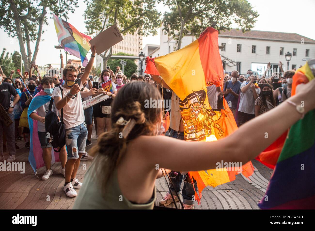 Barcelona, Spain. 22nd July, 2021. Protesters are seen burning a Spanish Francoist flag during the demonstration.Barcelona's transgender collective, Furia Trans (fury trans) have invaded a demonstration called by Pride Barcelona and the LGTBIcat Platform against LGBTI-fòbia, accusing them of excluding many of the realities of the LGBTIQ   movement, and of appropriation and commercialization of the movement. The Trans fury has followed the route and protesters from the other demonstration will join them totaling to 4000 people. Credit: SOPA Images Limited/Alamy Live News Stock Photo