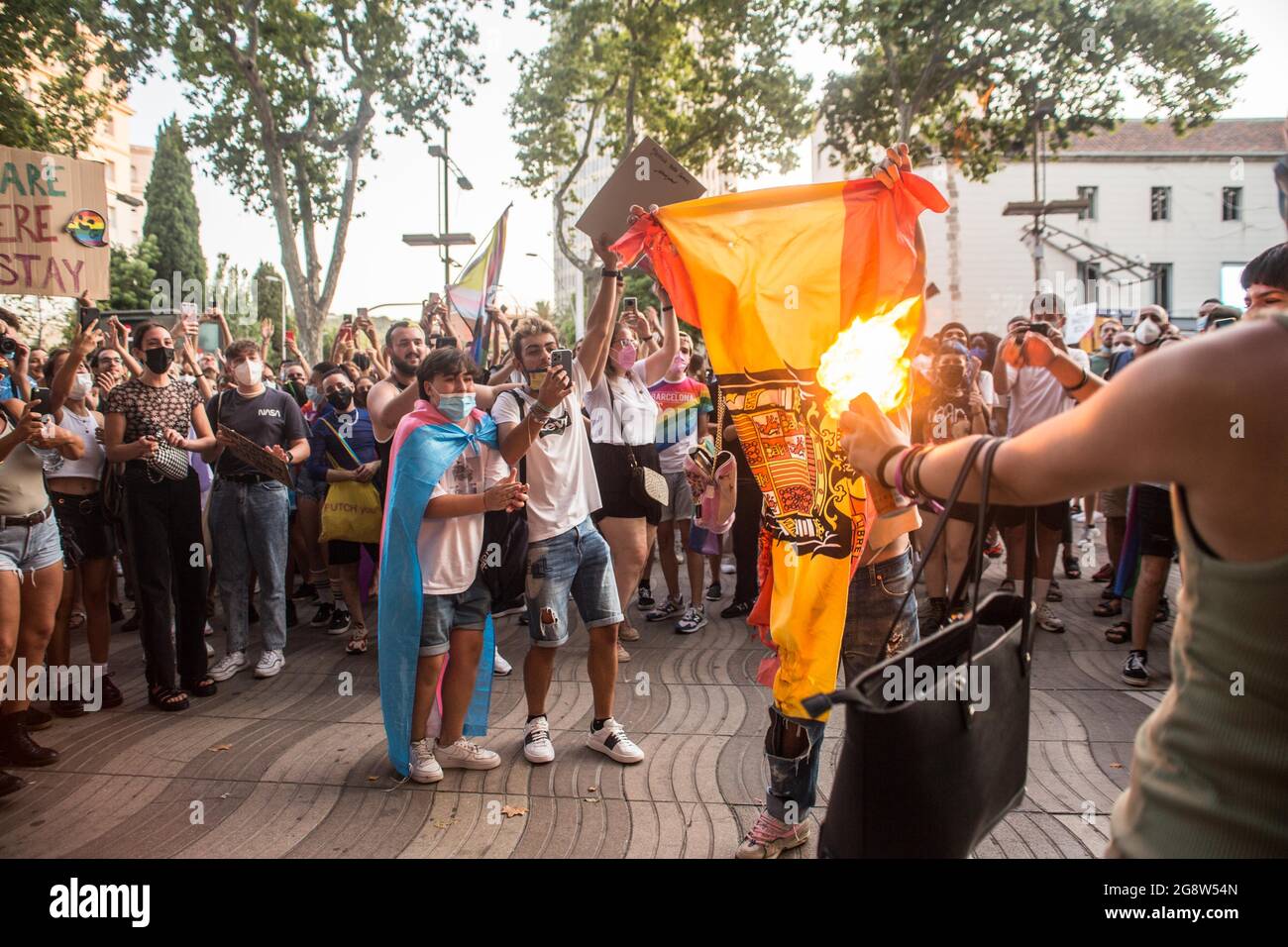 Barcelona, Spain. 22nd July, 2021. Protesters are seen burning a Spanish Francoist flag during the demonstration.Barcelona's transgender collective, Furia Trans (fury trans) have invaded a demonstration called by Pride Barcelona and the LGTBIcat Platform against LGBTI-fòbia, accusing them of excluding many of the realities of the LGBTIQ   movement, and of appropriation and commercialization of the movement. The Trans fury has followed the route and protesters from the other demonstration will join them totaling to 4000 people. Credit: SOPA Images Limited/Alamy Live News Stock Photo