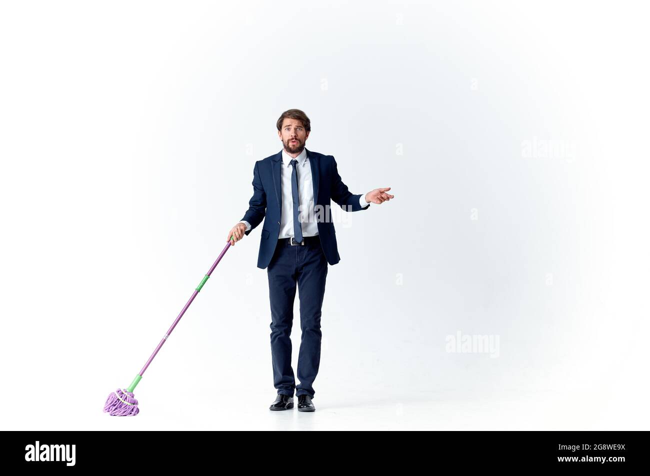 business man in a suit manager work cleaning with a mop Stock Photo