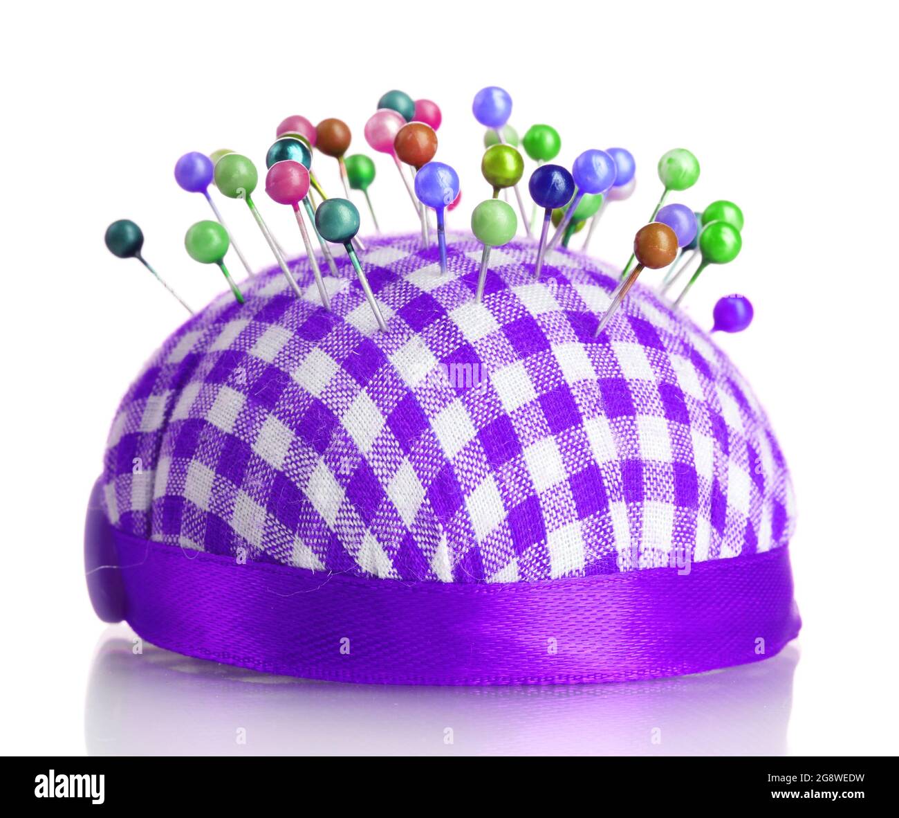 Colored pinheads in pincushion isolated on white Stock Photo Alamy