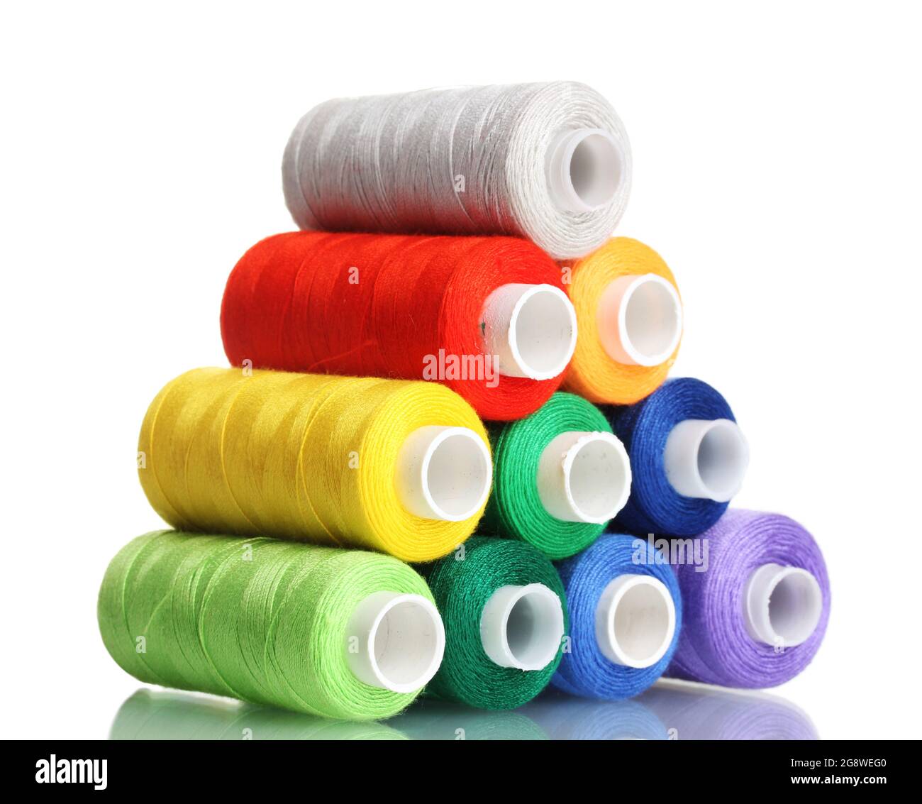 Pyramid Of Many Coloured Bobbins Of Thread Isolated On White Stock