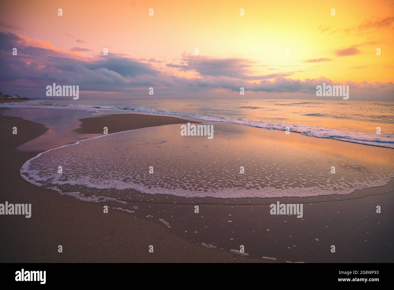 Seascape in the evening. Sunset over the sea with the beautiful blazing ...