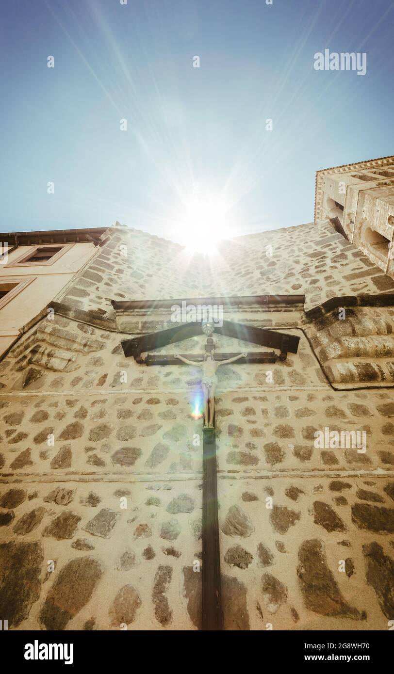 Vertical low angle shot of a church in Toledo, Spain with a small Jesus ...