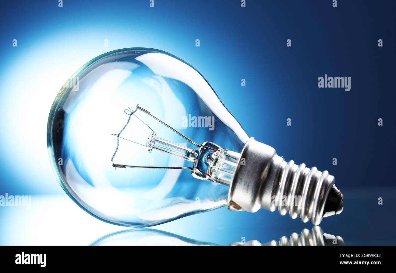 Light bulb on blue background Stock Photo - Alamy