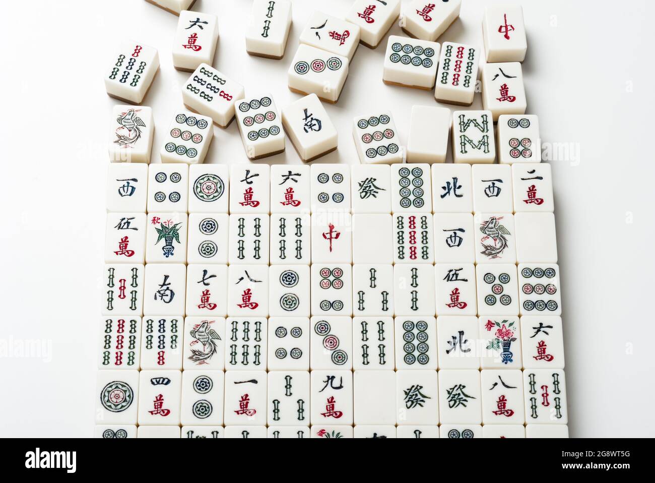 Many old mahjong tiles on white background. Mahjong is the ancient