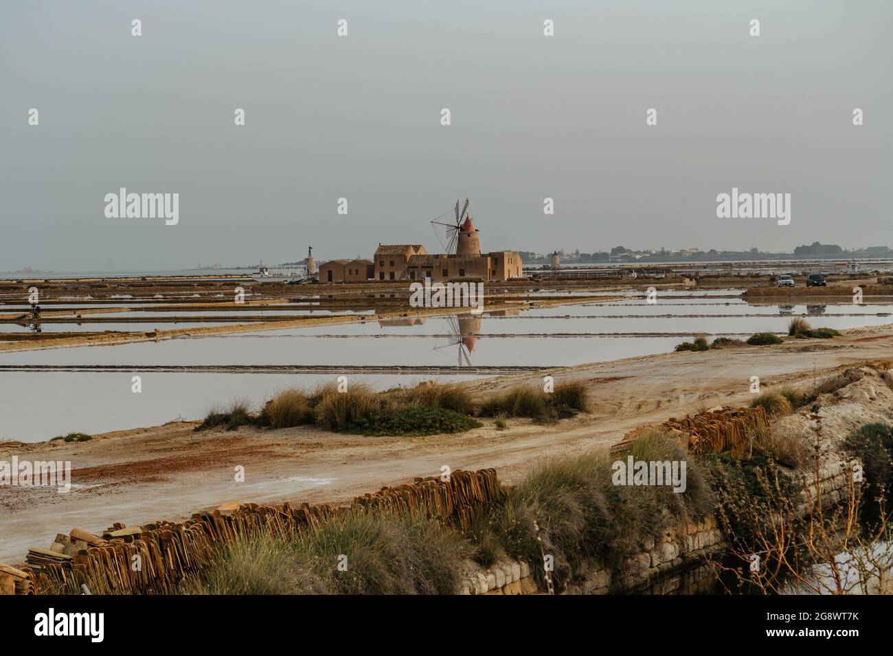 Saline of the Laguna Marsala,Sicily,Italy.Nature reserve with beautiful windmills,brine pools shimmering with different colors,traditional production Stock Photo