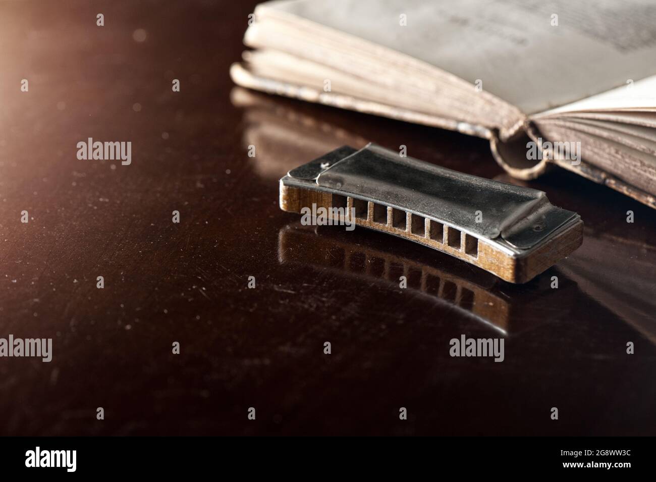 vintage wooden harmonica lying on wooden desk. Stock Photo